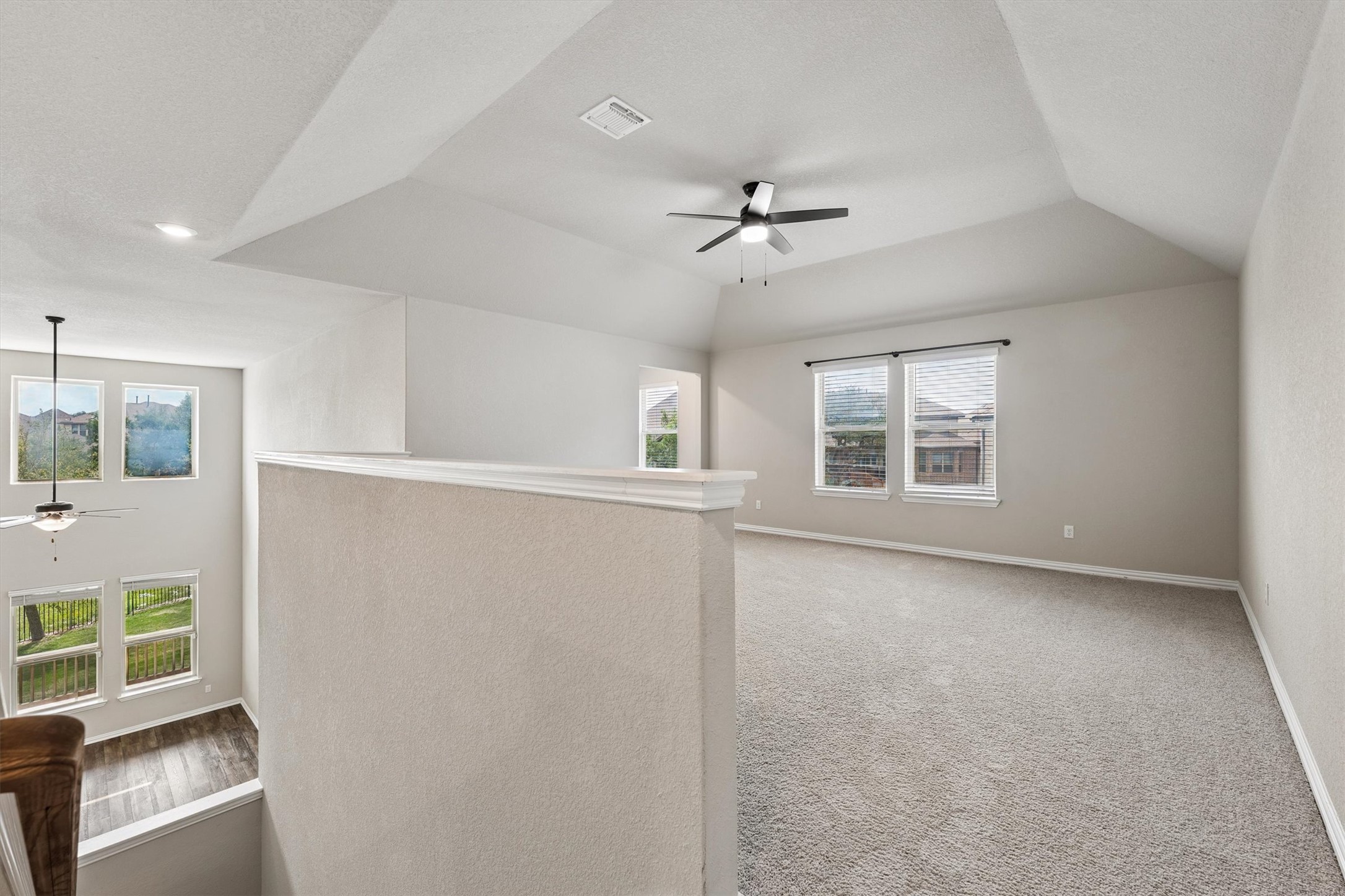 324 Autumn Oak Way Georgetown, TX 78628 - Photo 23 of 40 Spacious upper-level loft featuring vaulted ceilings, neutral-toned carpeting, and multiple windows with blinds