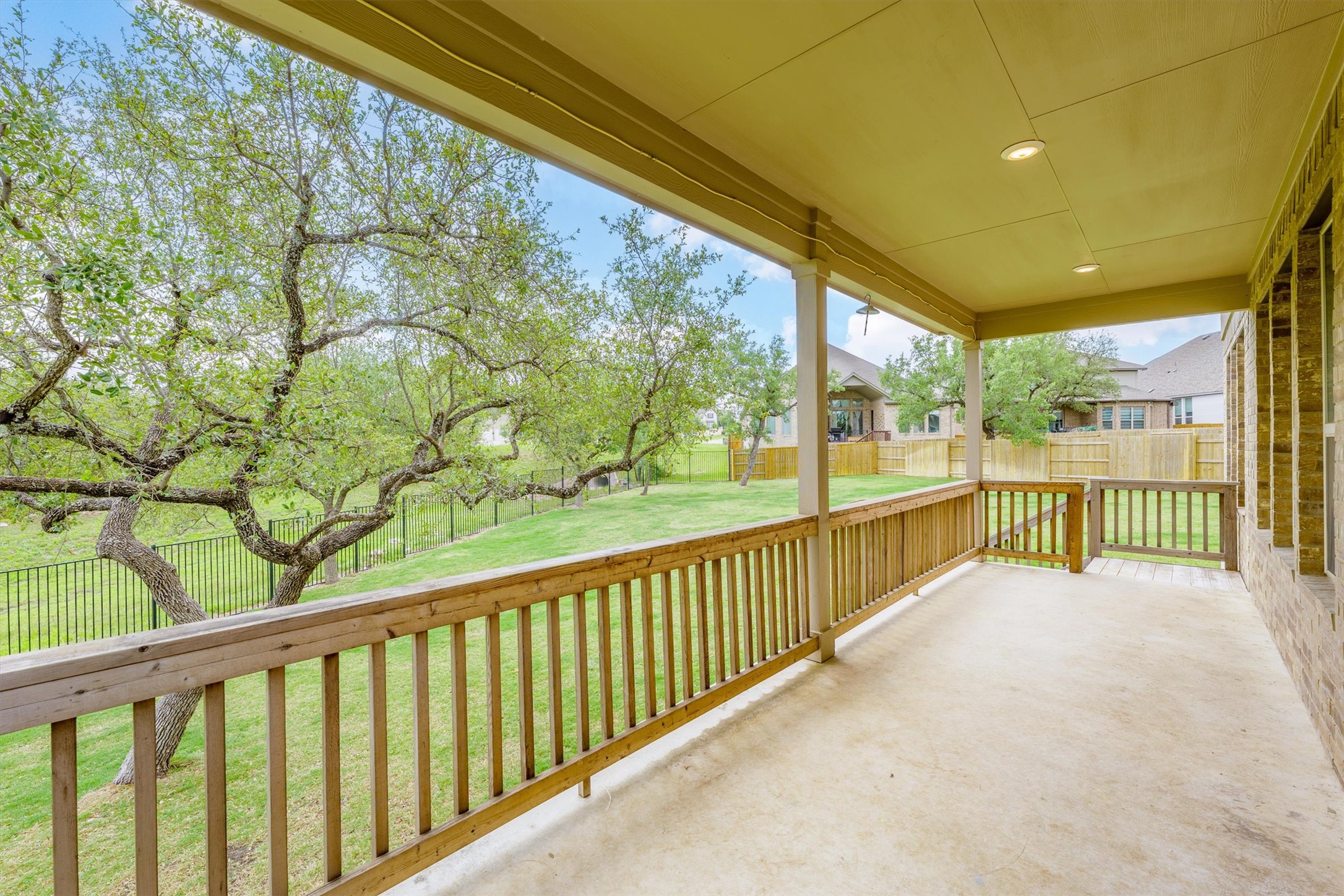 324 Autumn Oak Way Georgetown, TX 78628 - Photo 32 of 40 Spacious covered patio with concrete flooring, wood railing, recessed lighting, and brick exterior wall