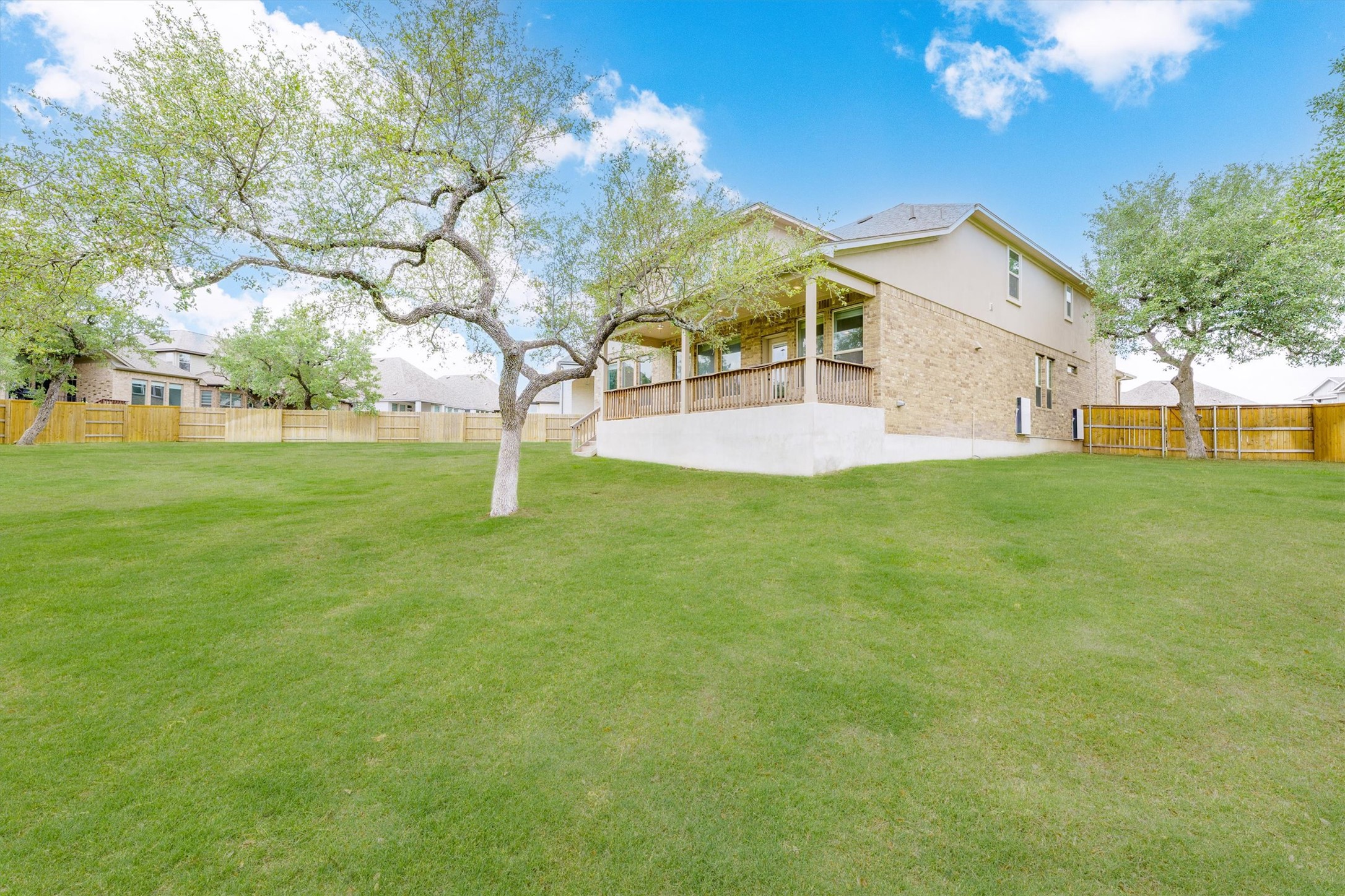 324 Autumn Oak Way Georgetown, TX 78628 - Photo 33 of 40 Expansive green lawn with mature trees and a rear covered patio