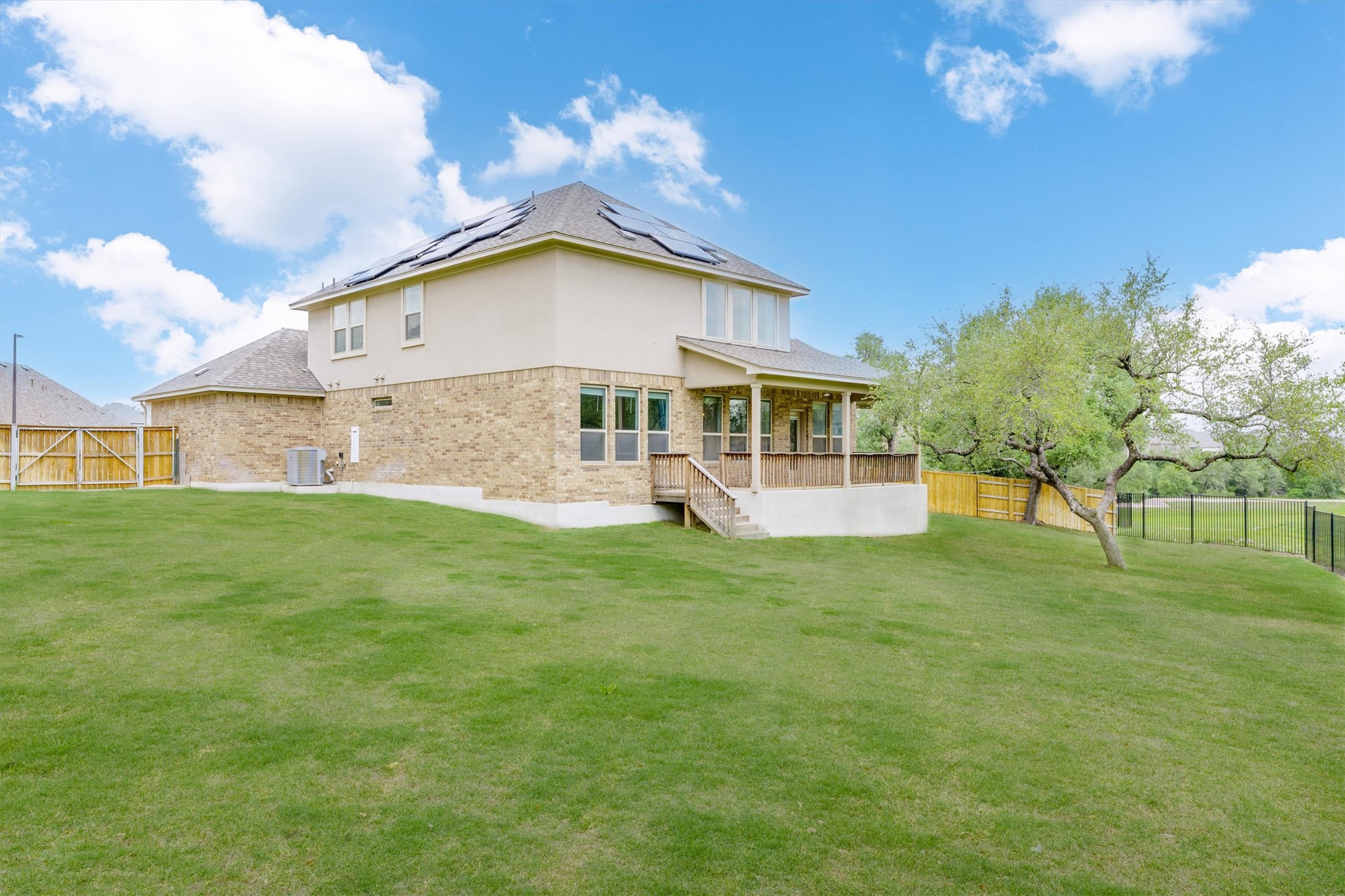 324 Autumn Oak Way Georgetown, TX 78628 - Photo 35 of 40 Expansive green lawn bordering a two-story residence with a covered patio