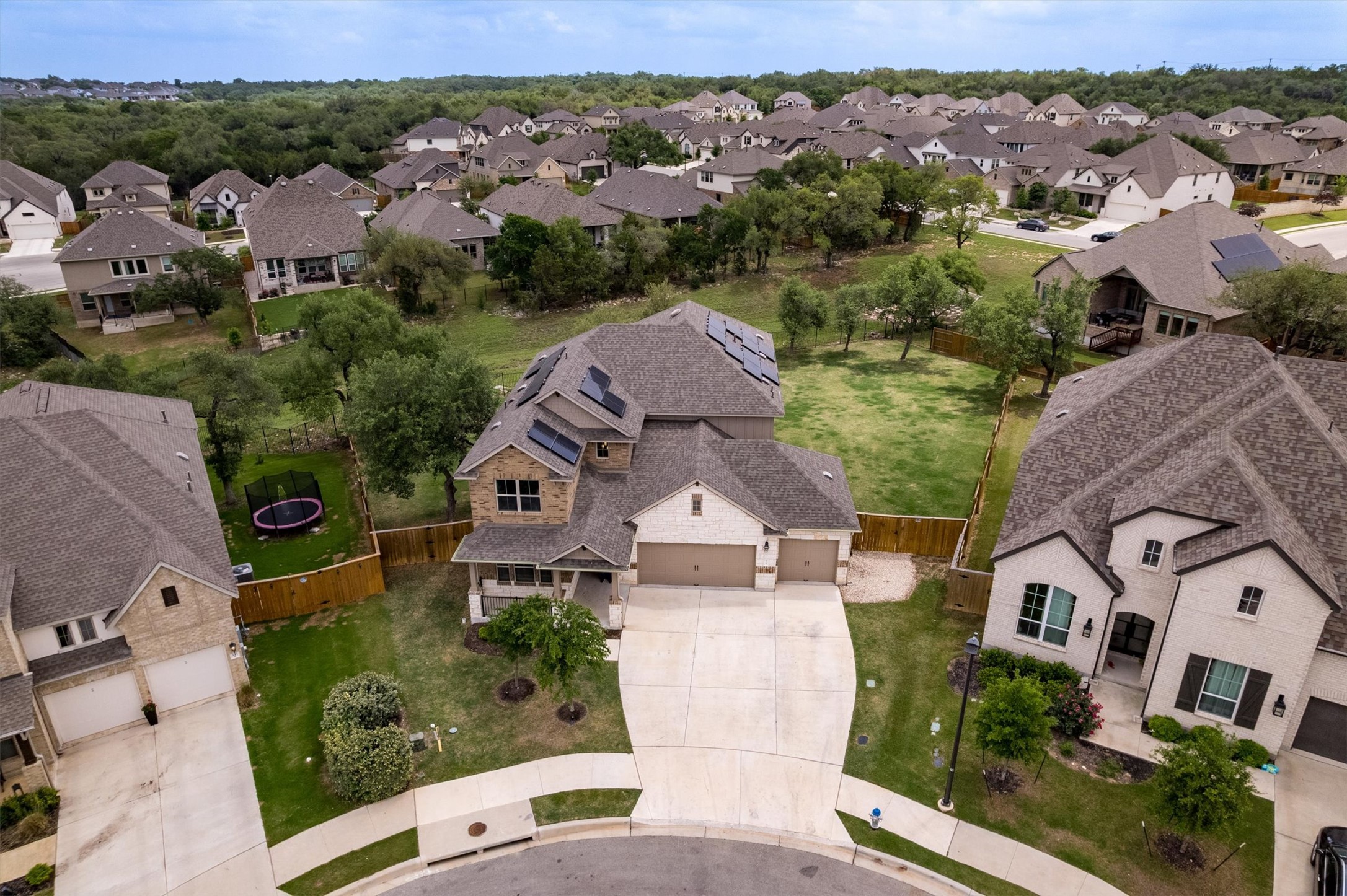 324 Autumn Oak Way Georgetown, TX 78628 - Photo 36 of 40 Exterior featuring a two-car garage, stone and brick facade, covered entry, and solar panels