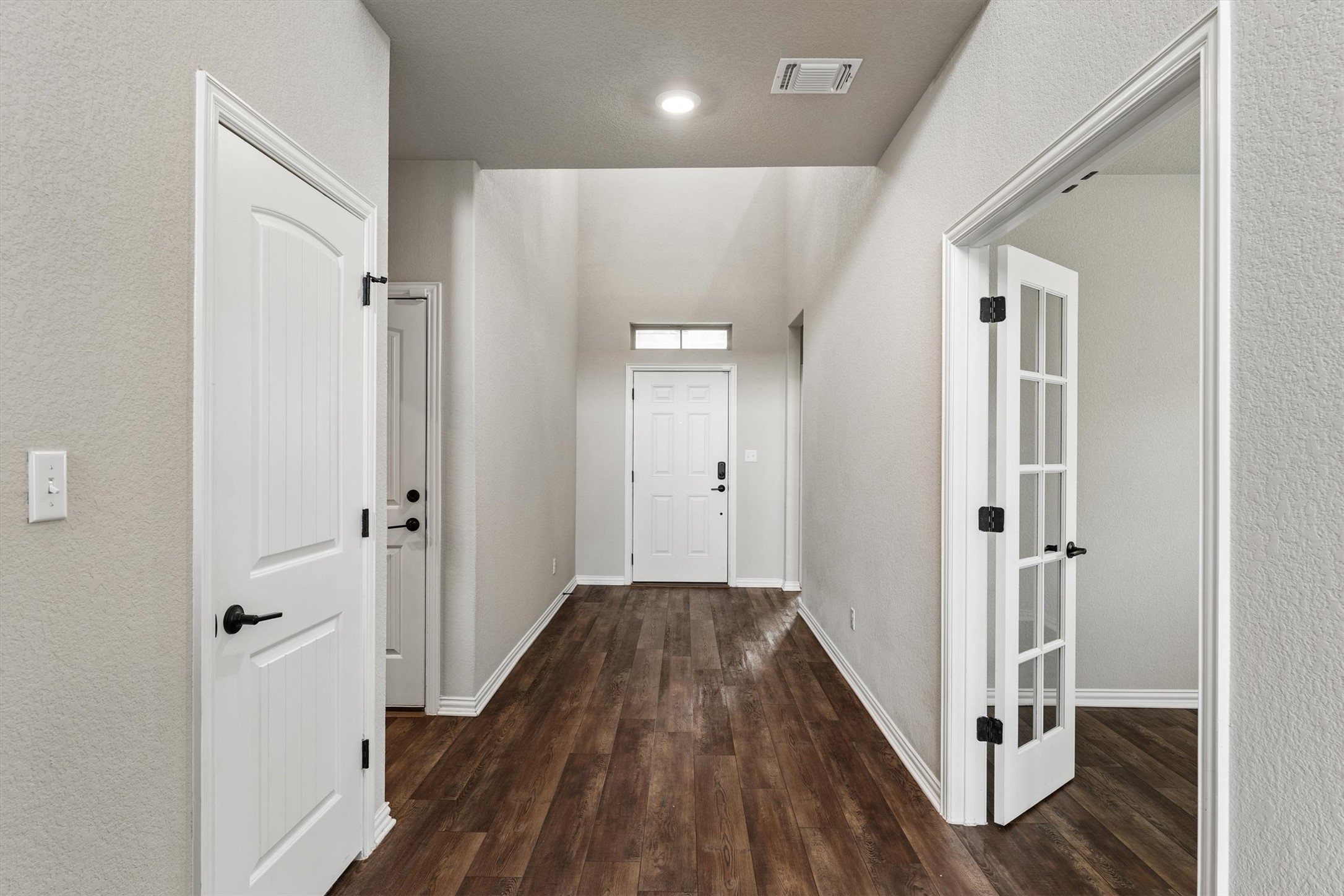 324 Autumn Oak Way Georgetown, TX 78628 - Photo 4 of 40 Entry hallway featuring wood-finish flooring, white baseboards, and light neutral wall finishes