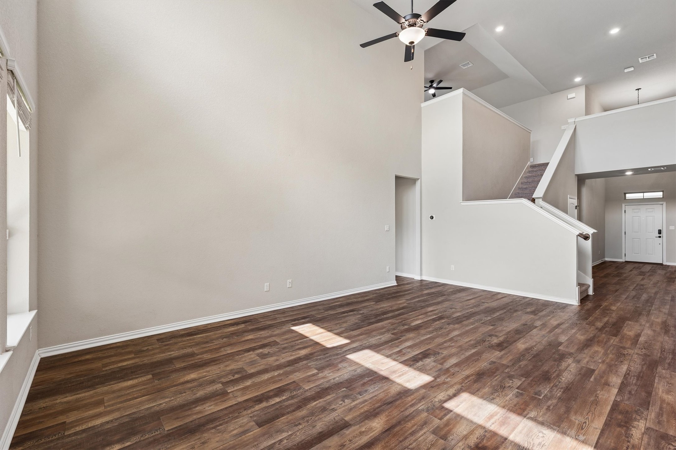 324 Autumn Oak Way Georgetown, TX 78628 - Photo 7 of 40 Expansive living area featuring soaring ceilings and wood-finish flooring
