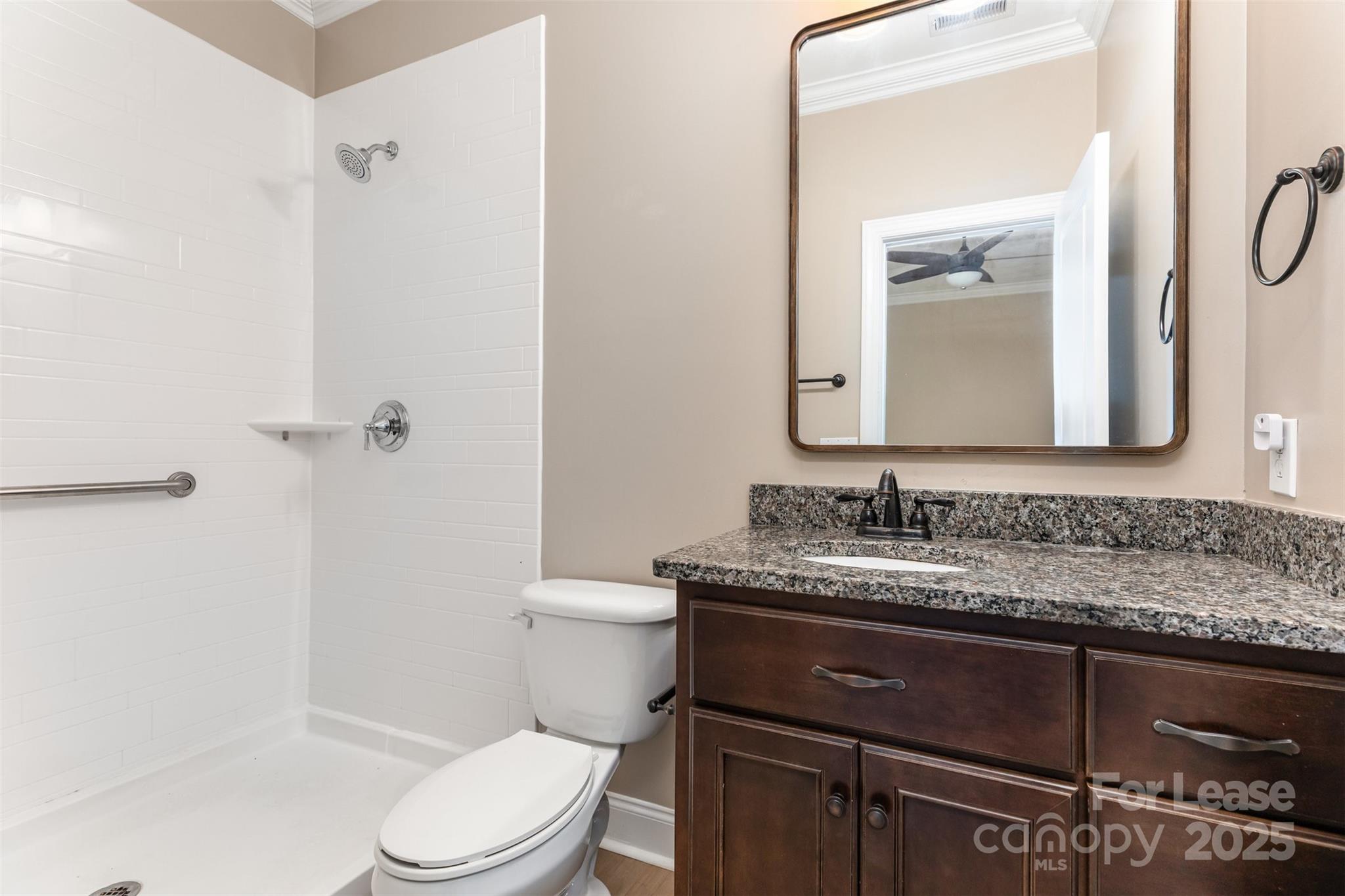 540 Greystone Road Charlotte, NC 28209 - Photo 12 of 18 a bathroom with a granite countertop sink toilet a mirror and shower