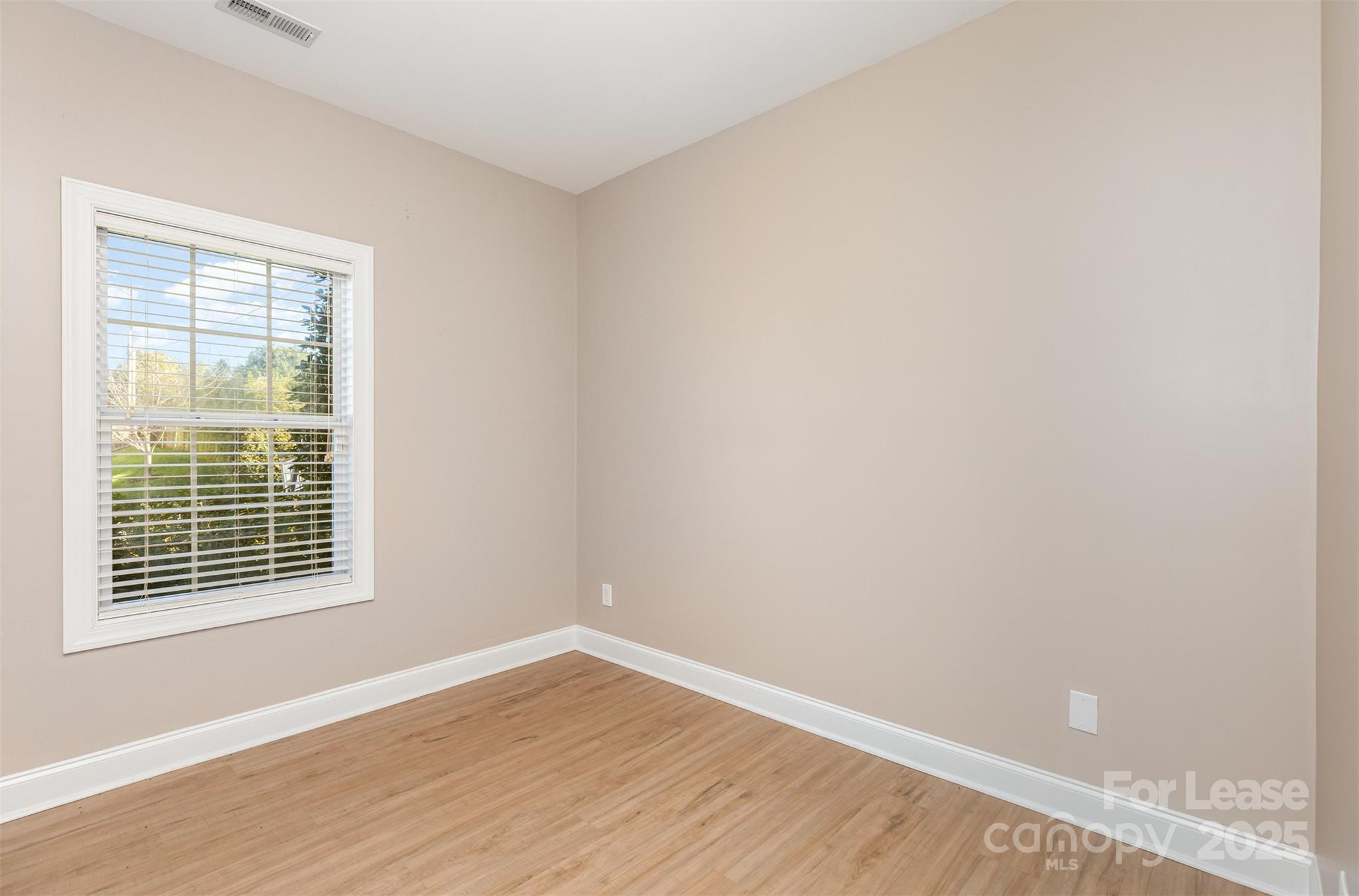 540 Greystone Road Charlotte, NC 28209 - Photo 14 of 18 a view of an empty room with wooden floor and a window