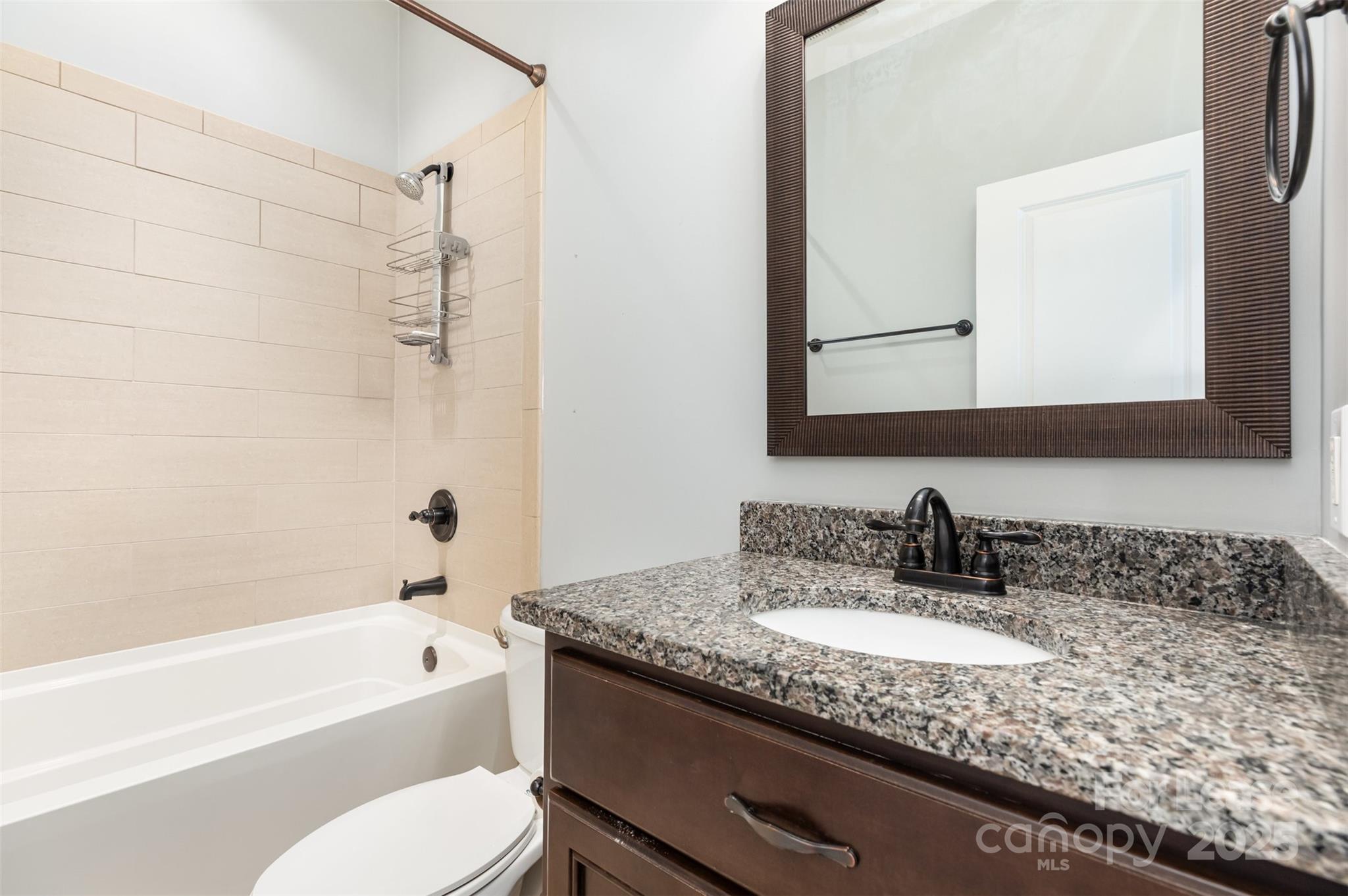 540 Greystone Road Charlotte, NC 28209 - Photo 15 of 18 a bathroom with a granite countertop sink mirror toilet and bathtub