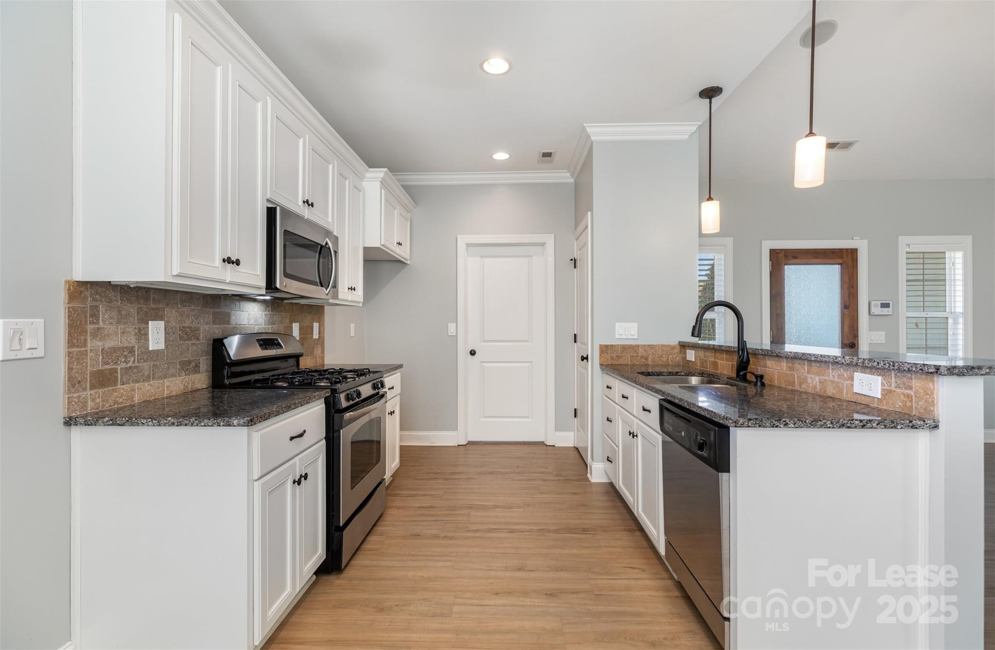 540 Greystone Road Charlotte, NC 28209 - Photo 5 of 18 a large kitchen with stainless steel appliances granite countertop a lot of counter space and a sink