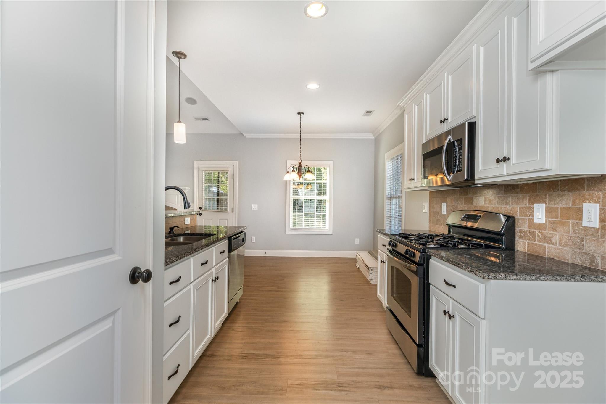 540 Greystone Road Charlotte, NC 28209 - Photo 6 of 18 a kitchen with stainless steel appliances a stove sink and cabinets