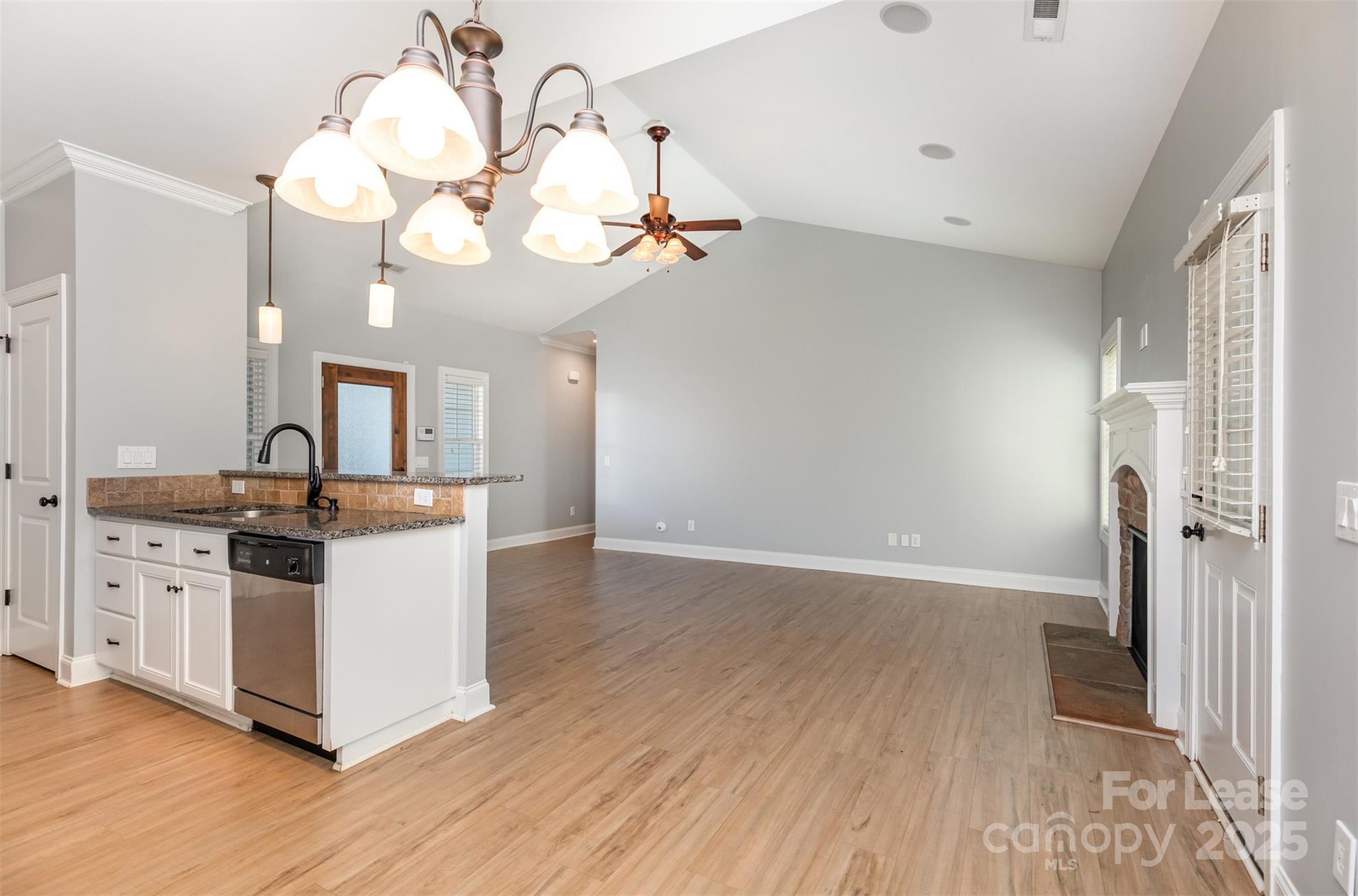 540 Greystone Road Charlotte, NC 28209 - Photo 9 of 18 a view of a kitchen counter space wooden floor and a ceiling fan