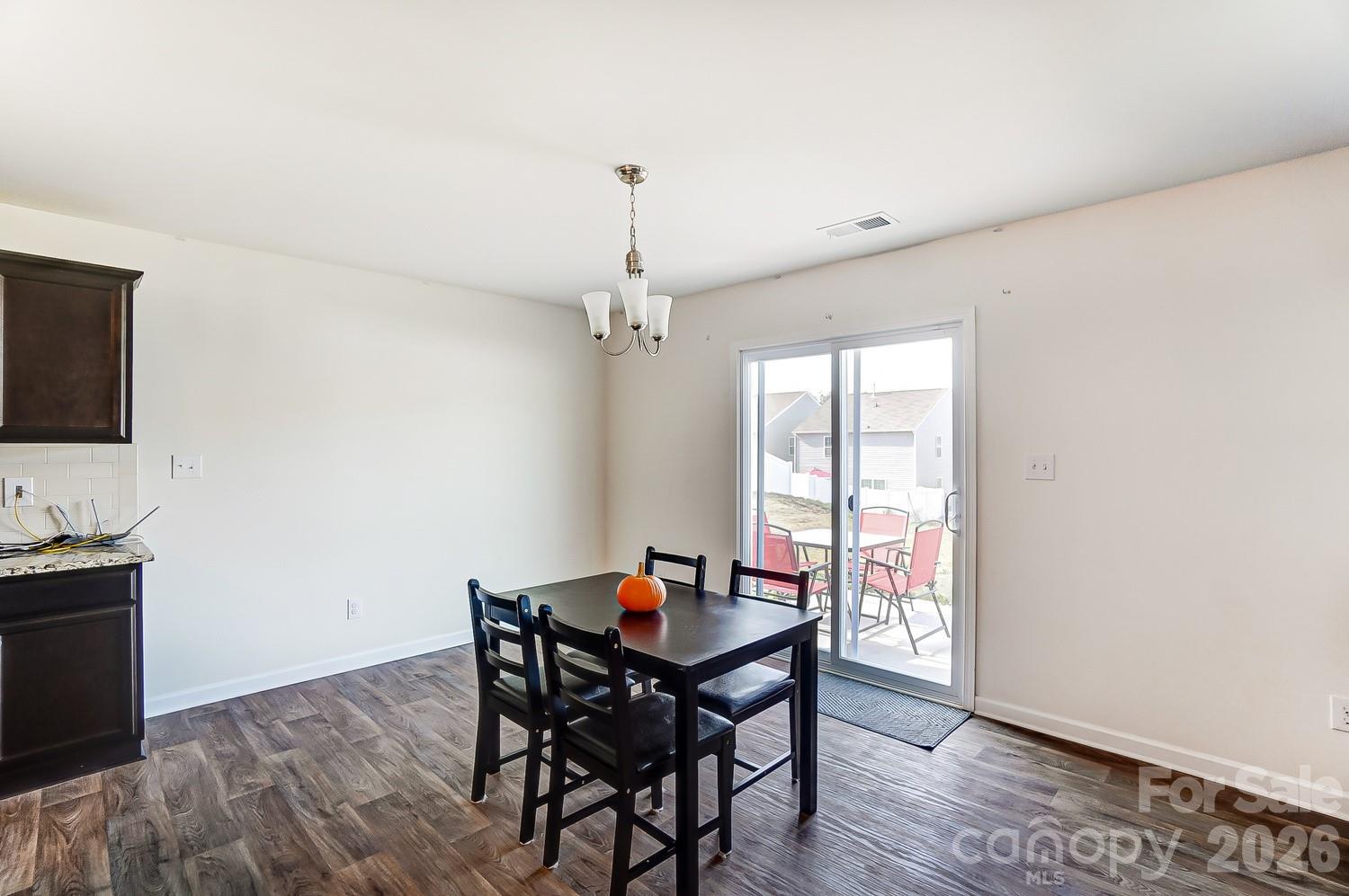 618 Bloomover Street Concord, NC 28025 - Photo 16 of 45 a view of a dining room with furniture window and wooden floor