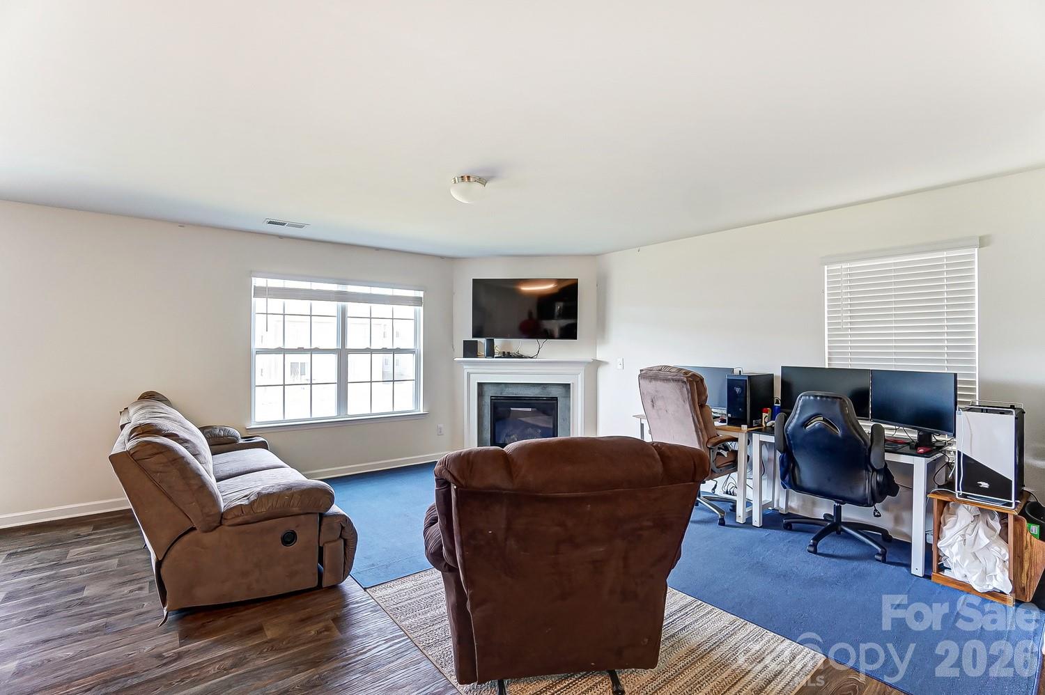 618 Bloomover Street Concord, NC 28025 - Photo 5 of 45 a living room with furniture a fireplace and a flat screen tv