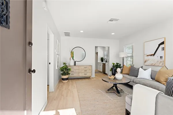 a living room with furniture a rug and white walls