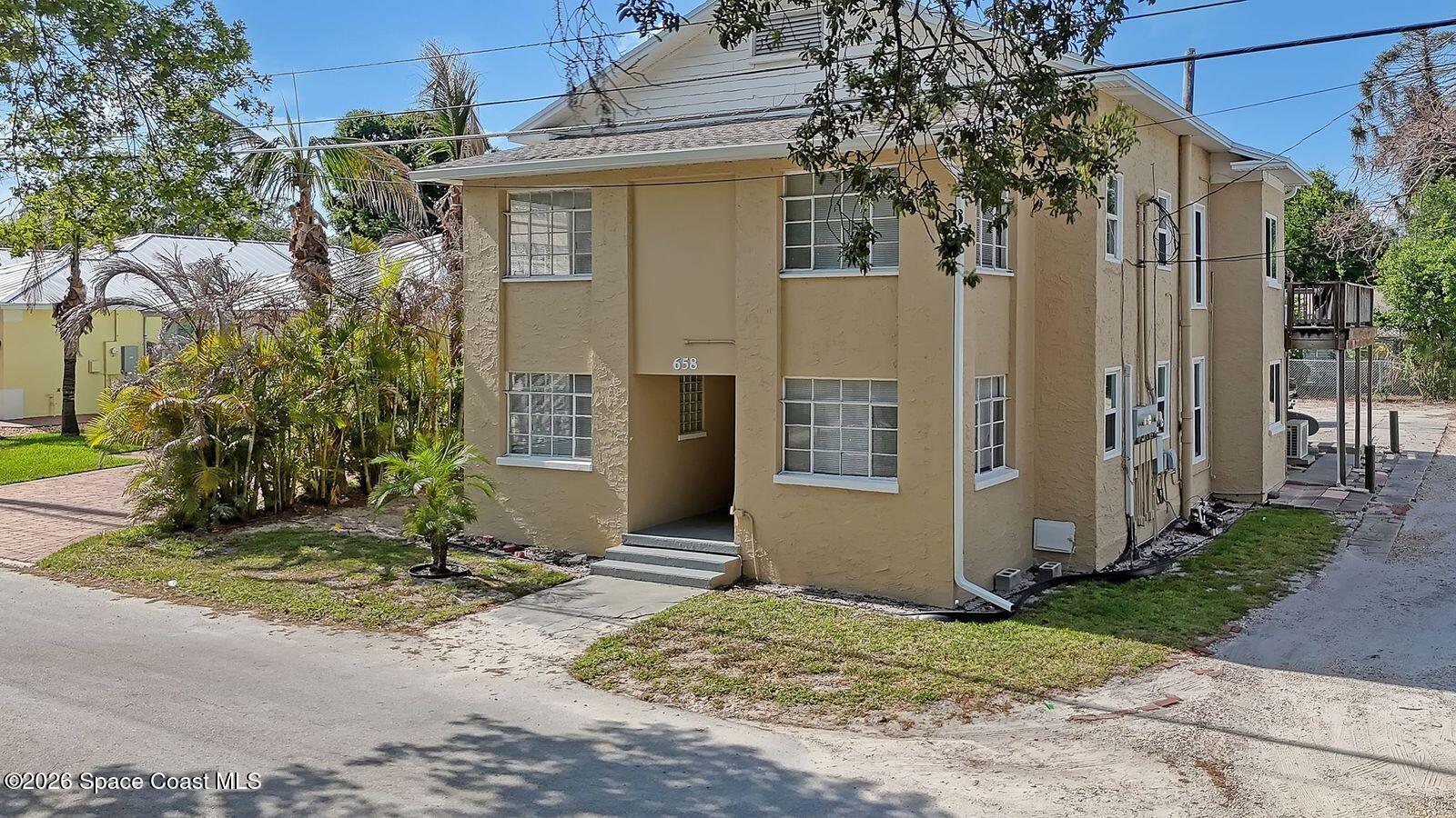 658 Young Street Melbourne, FL 32935 - Photo 1 of 77 a front view of a house with a yard