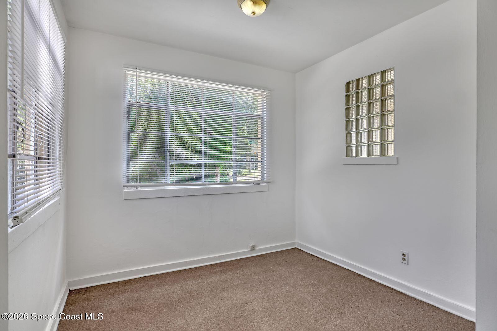 658 Young Street Melbourne, FL 32935 - Photo 11 of 77 an empty room with windows