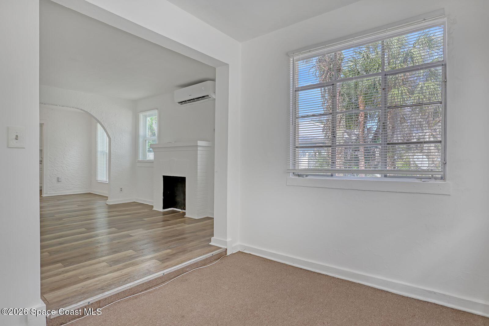 658 Young Street Melbourne, FL 32935 - Photo 12 of 77 a view of a livingroom with wooden floor and a fireplace