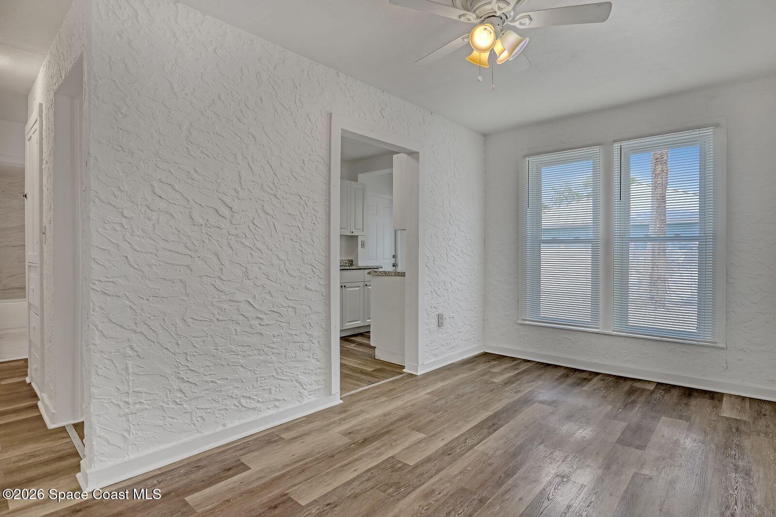 658 Young Street Melbourne, FL 32935 - Photo 13 of 77 wooden floor in an empty room with a window