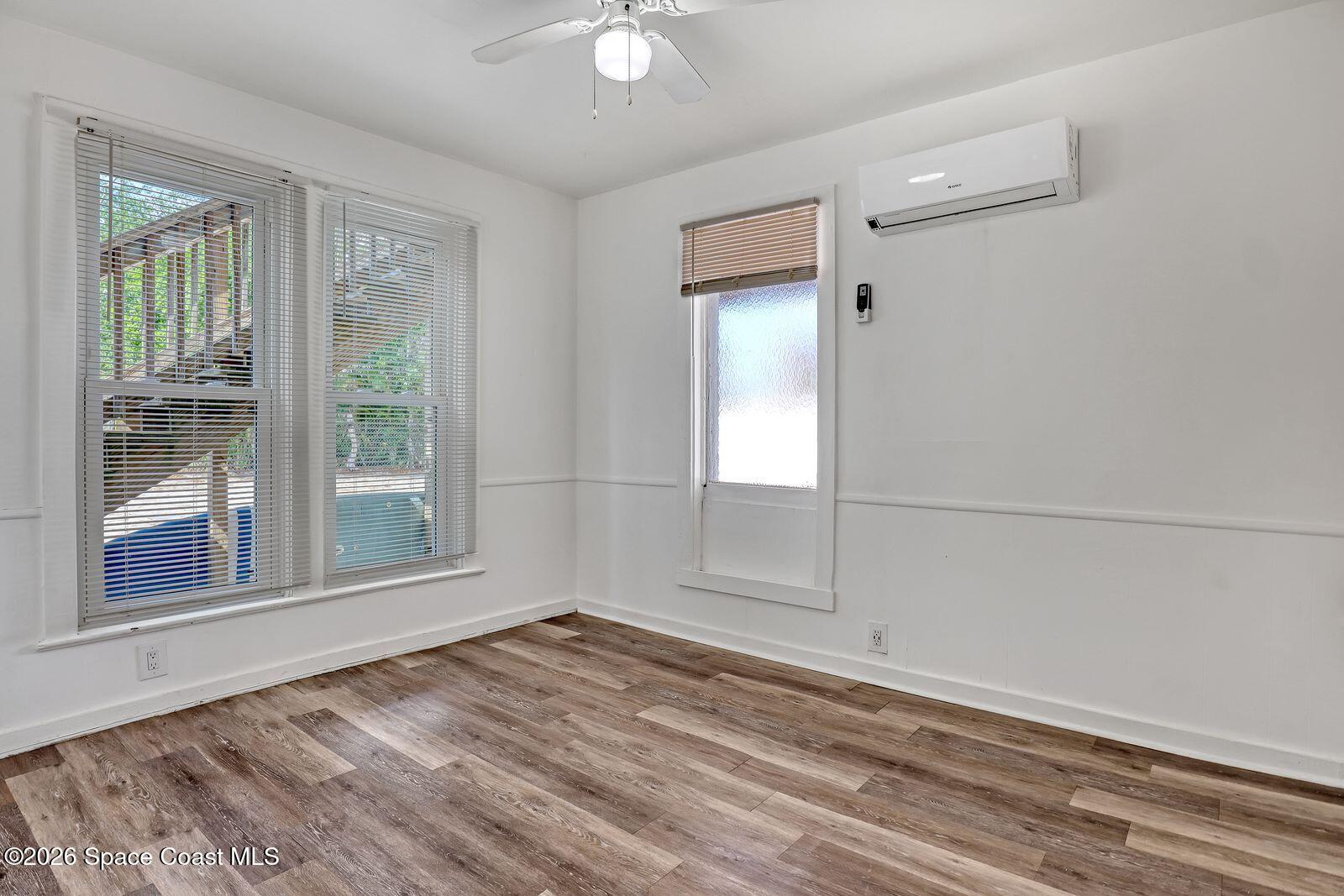 658 Young Street Melbourne, FL 32935 - Photo 17 of 77 wooden floor in an empty room with a window