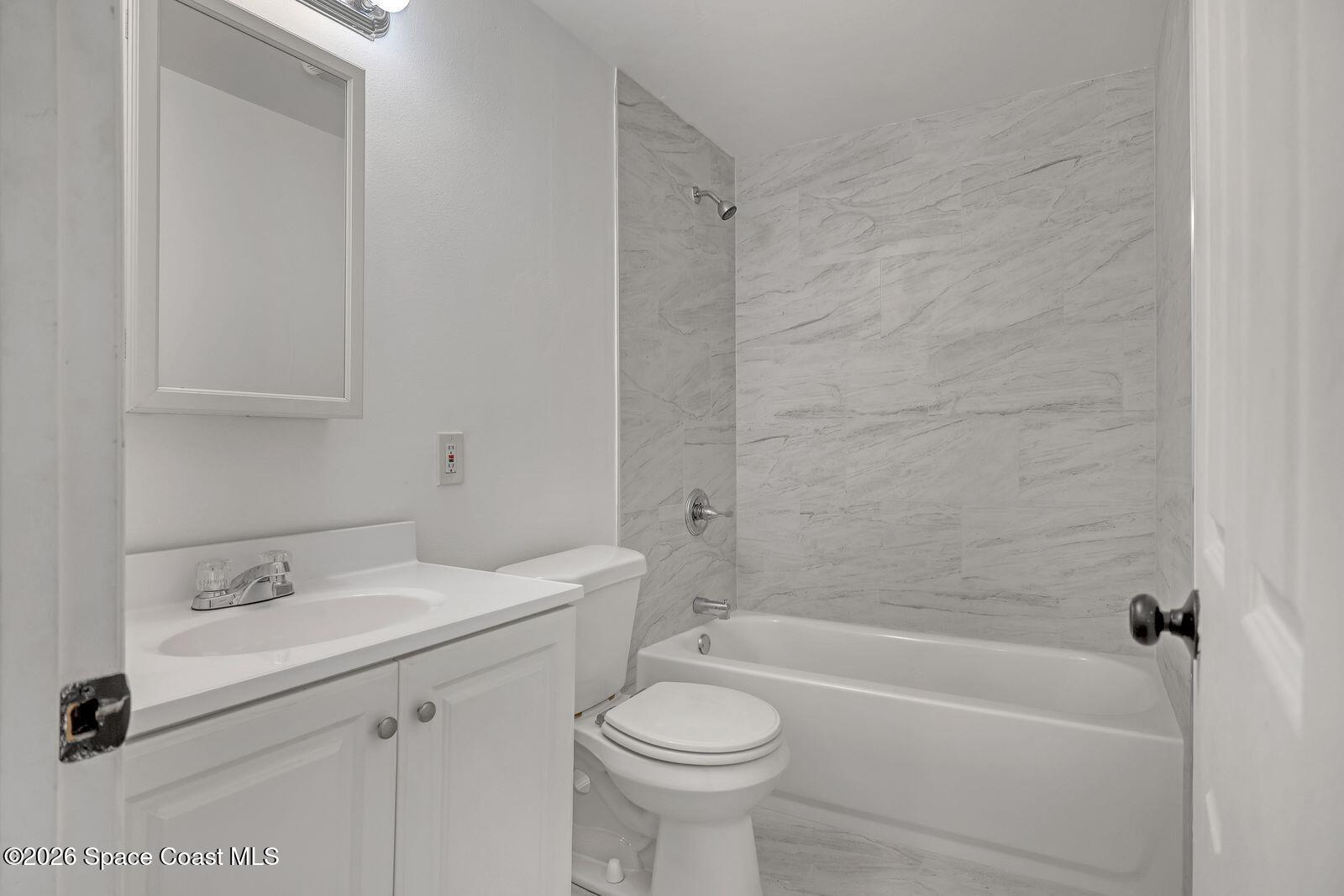 658 Young Street Melbourne, FL 32935 - Photo 19 of 77 a bathroom with a sink a toilet and a bathtub