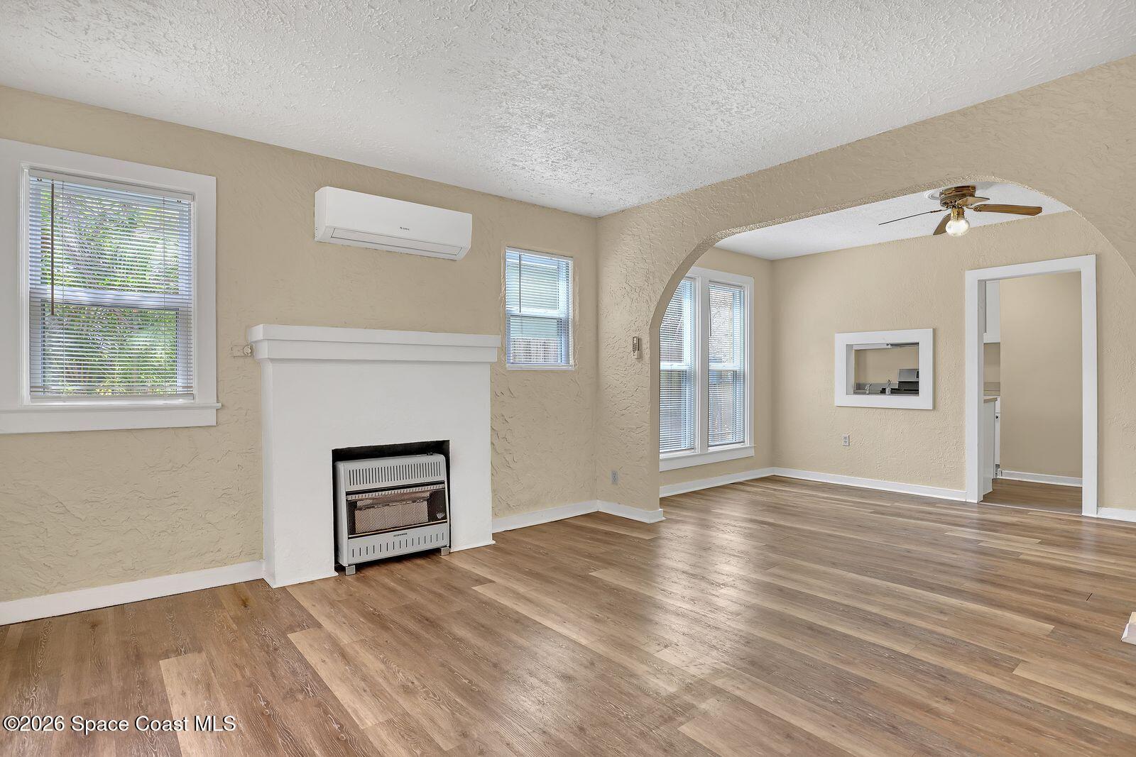 658 Young Street Melbourne, FL 32935 - Photo 21 of 77 a view of an empty room with a window and wooden floor