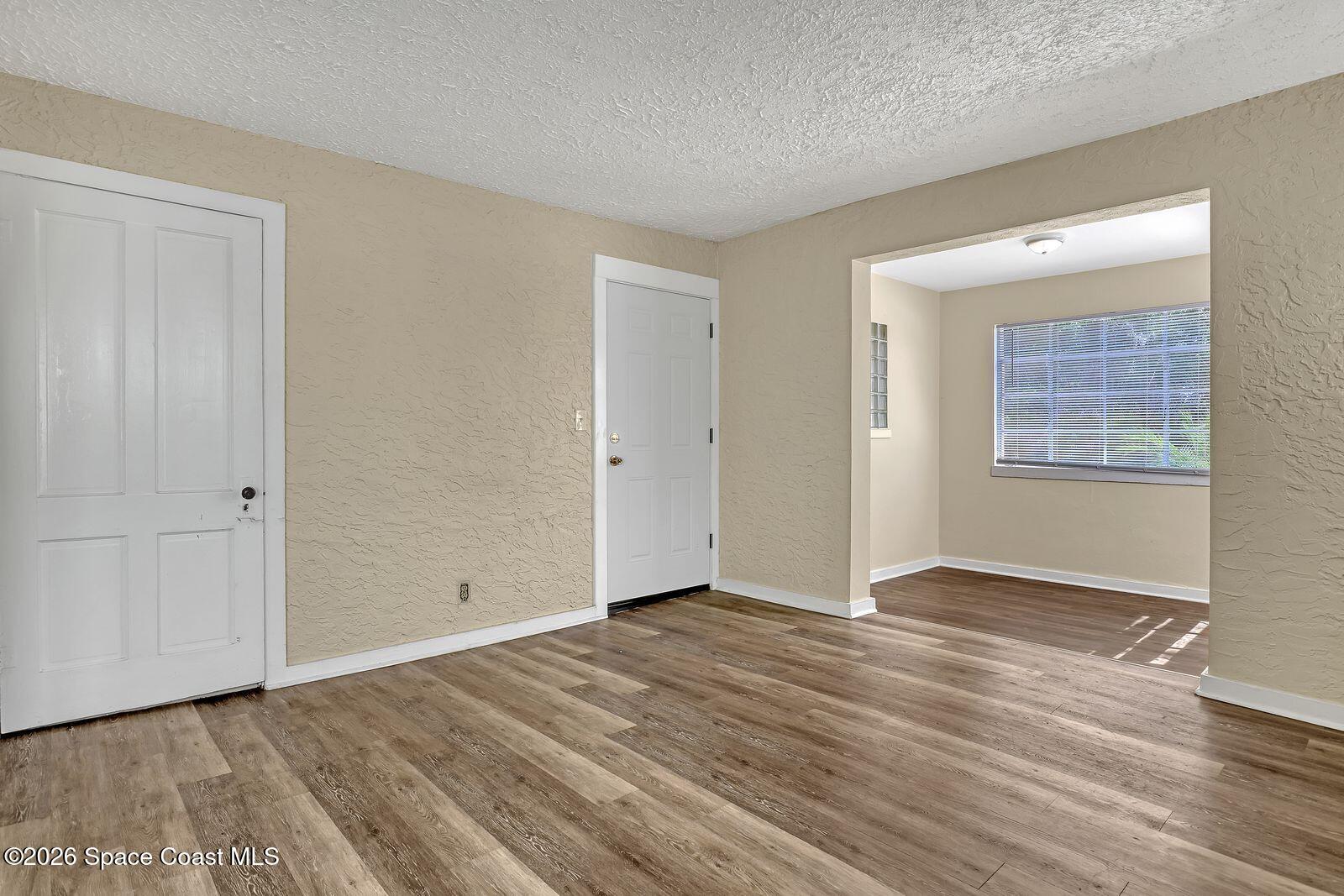 658 Young Street Melbourne, FL 32935 - Photo 23 of 77 a view of an empty room with wooden floor and a window