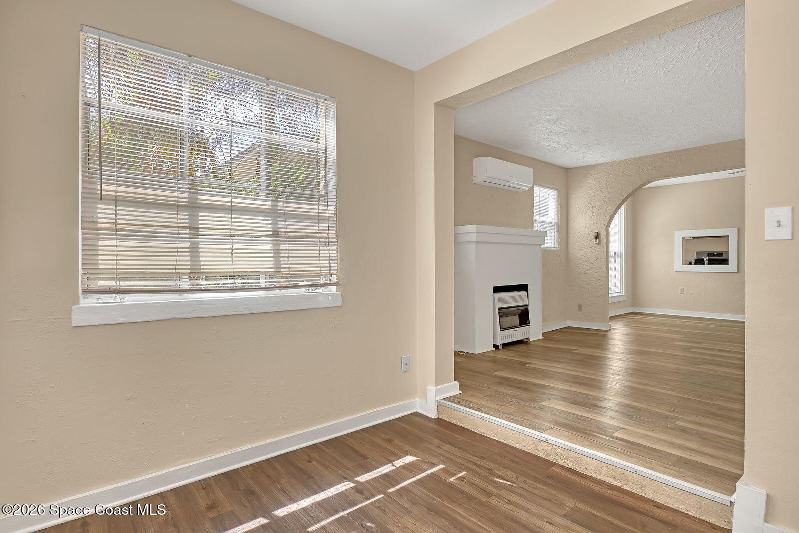 658 Young Street Melbourne, FL 32935 - Photo 25 of 77 a view of an empty room with window and wooden floor