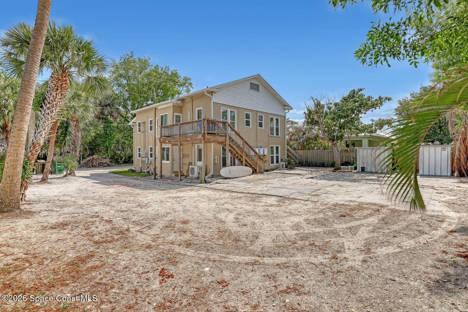 658 Young Street Melbourne, FL 32935 - Photo 3 of 77 a view of a house with wooden fence and large trees