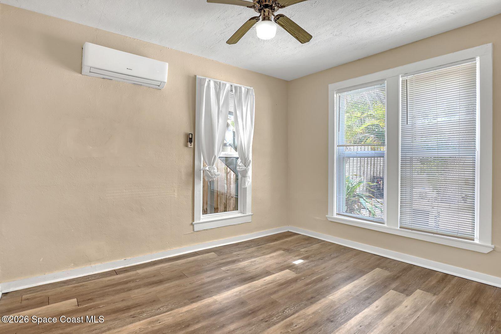 658 Young Street Melbourne, FL 32935 - Photo 33 of 77 a view of an empty room with a window and wooden floor