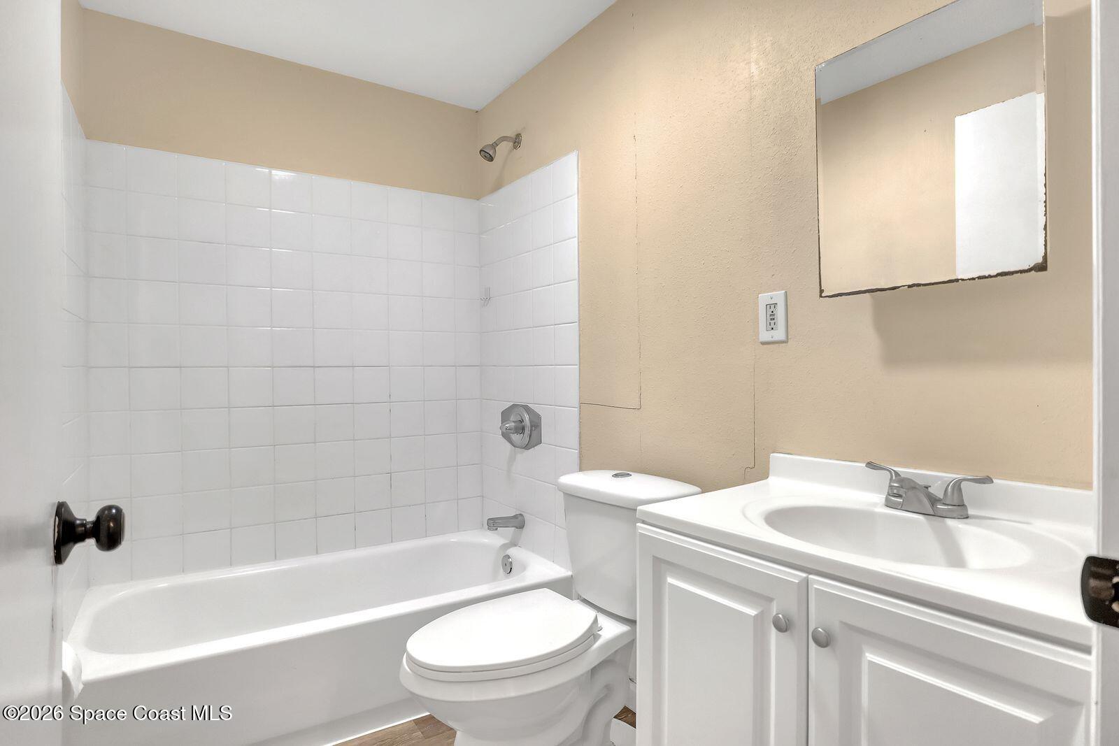 658 Young Street Melbourne, FL 32935 - Photo 35 of 77 a bathroom with a sink a toilet and a bathtub