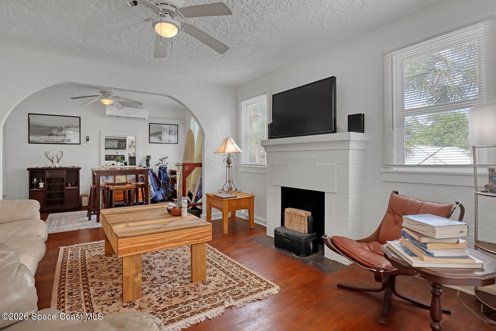 658 Young Street Melbourne, FL 32935 - Photo 40 of 77 a living room with furniture a flat screen tv and a fireplace