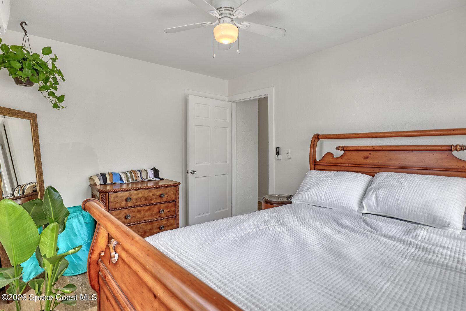 658 Young Street Melbourne, FL 32935 - Photo 51 of 77 a bedroom with a bed and a chandelier
