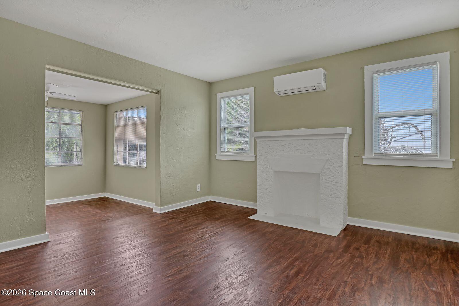 658 Young Street Melbourne, FL 32935 - Photo 54 of 77 an empty room with wooden floor and windows