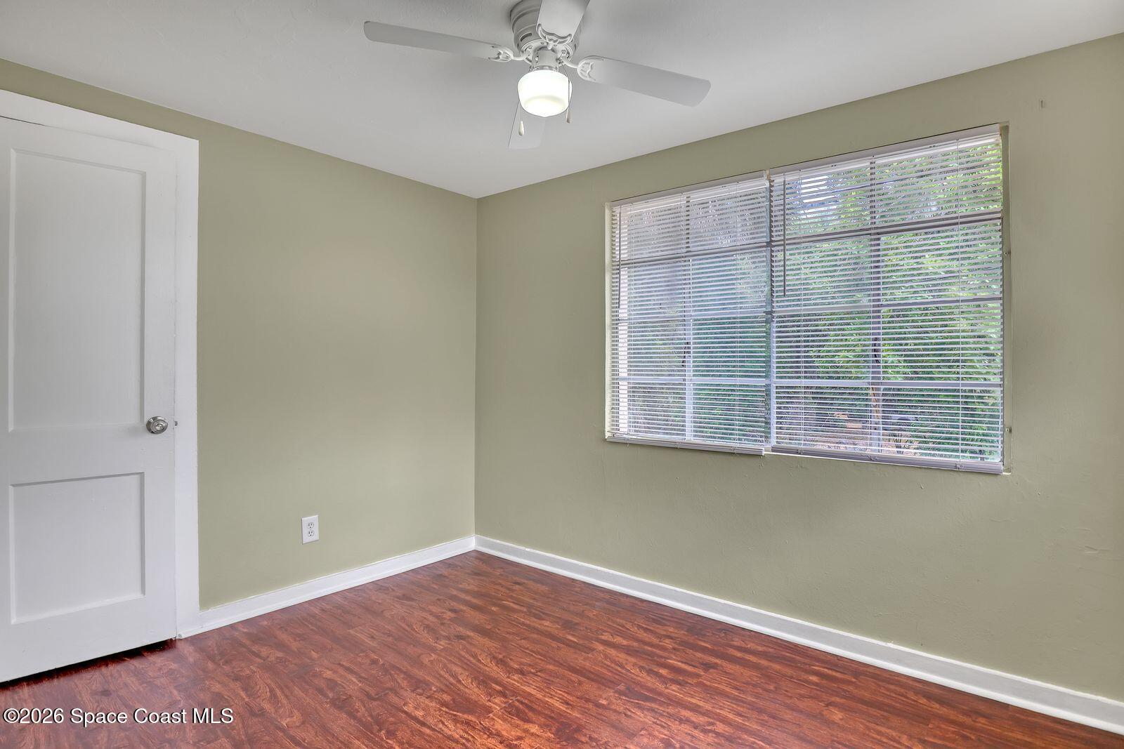 658 Young Street Melbourne, FL 32935 - Photo 57 of 77 a view of an empty room with wooden floor and a window