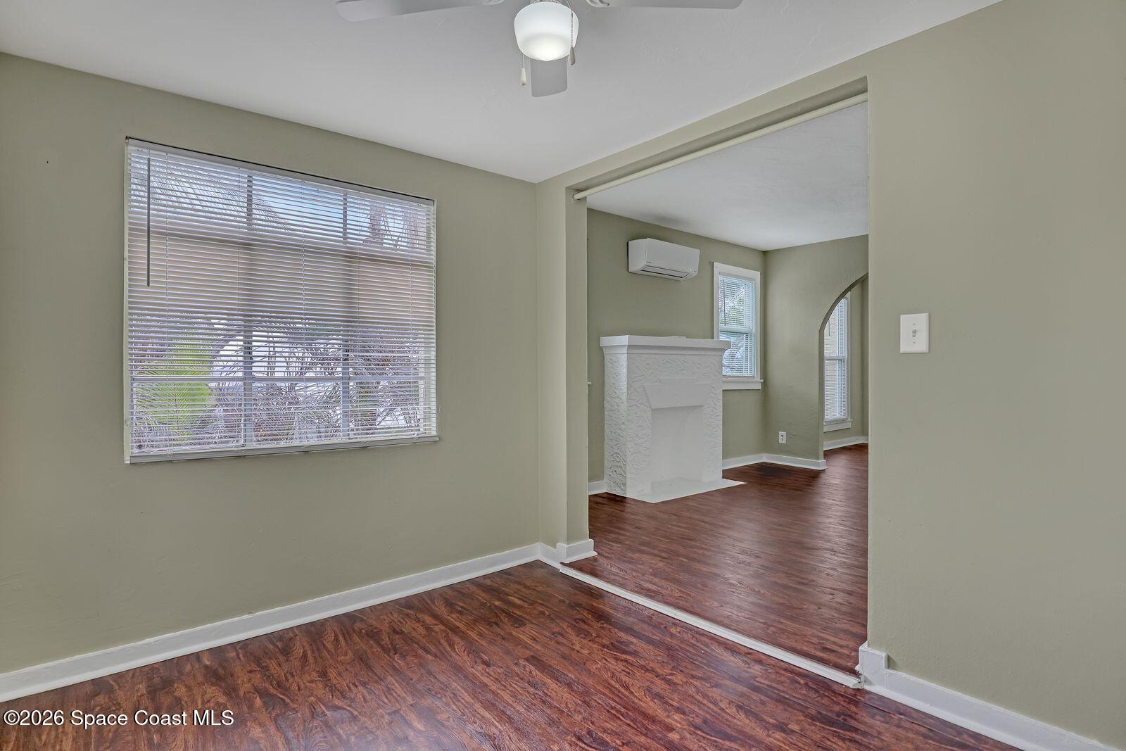 658 Young Street Melbourne, FL 32935 - Photo 58 of 77 a view of an empty room with wooden floor and a window