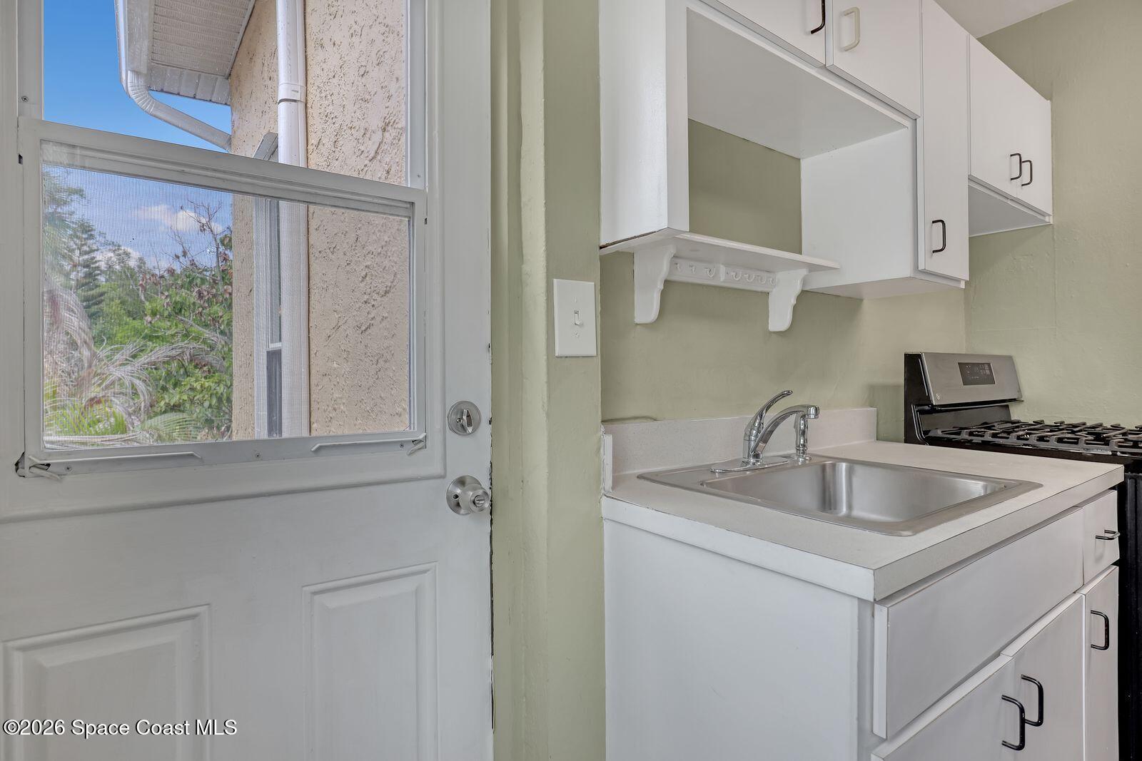 658 Young Street Melbourne, FL 32935 - Photo 65 of 77 a kitchen with stainless steel appliances granite countertop a sink and a cabinets