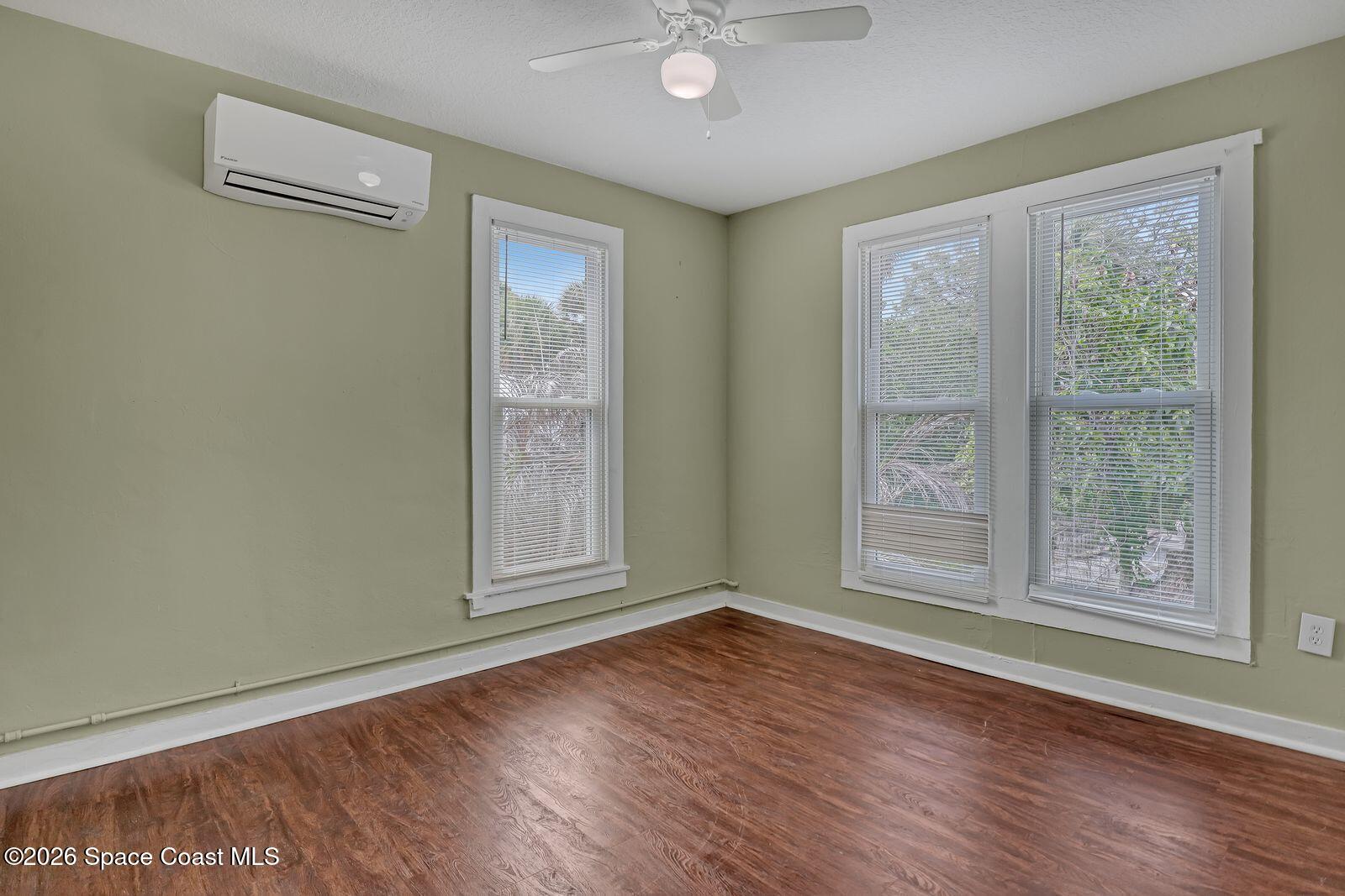 658 Young Street Melbourne, FL 32935 - Photo 68 of 77 an empty room with wooden floor and windows