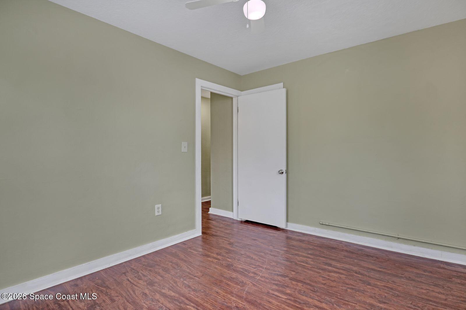 658 Young Street Melbourne, FL 32935 - Photo 69 of 77 a view of an empty room with wooden floor