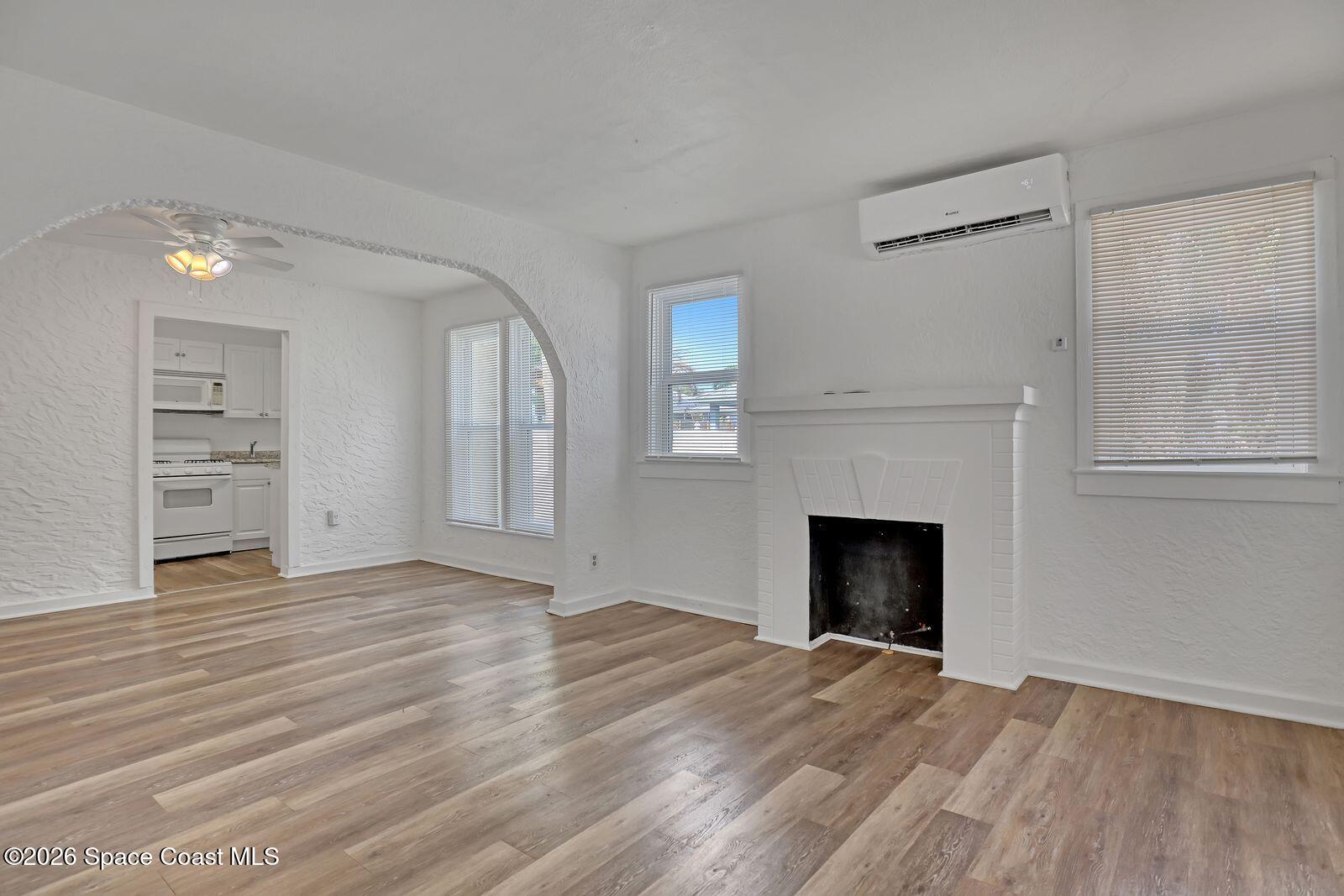 658 Young Street Melbourne, FL 32935 - Photo 7 of 77 a view of an empty room with a fireplace and a window