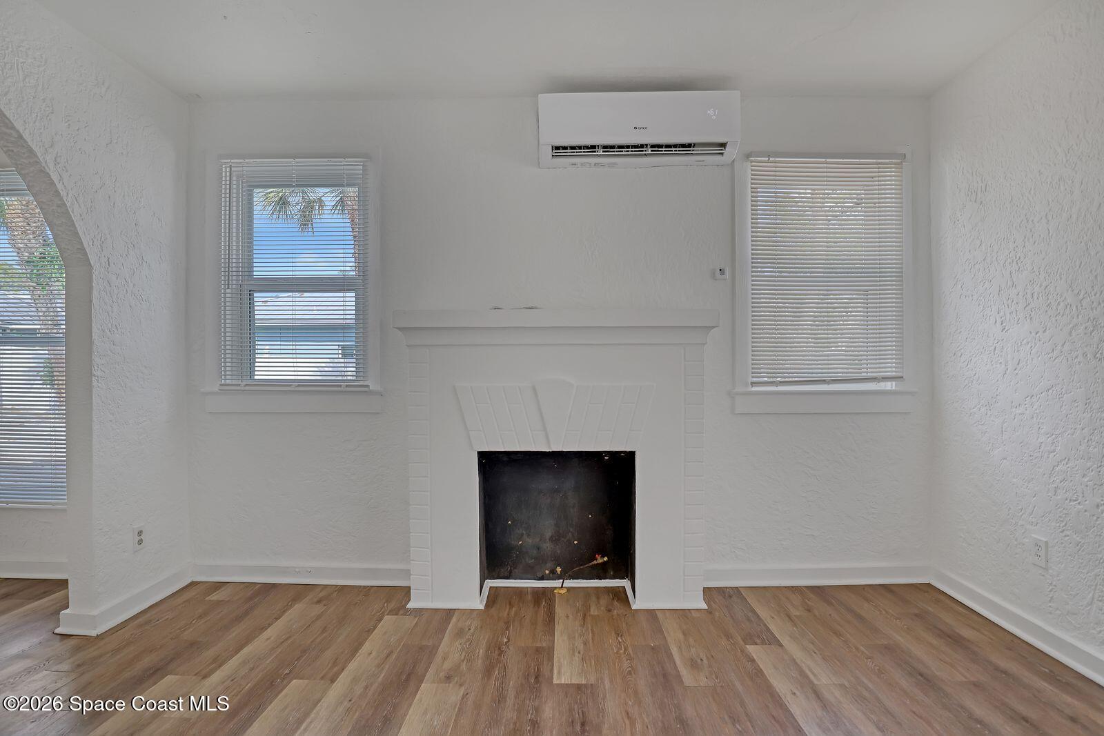 658 Young Street Melbourne, FL 32935 - Photo 9 of 77 a view of an empty room with wooden floor and a window