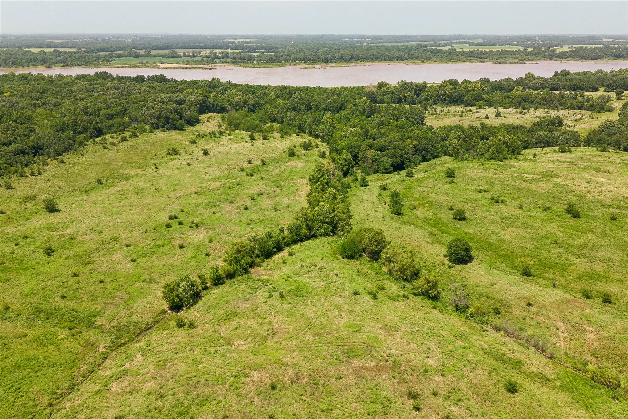 2 West Fern Mountain Road Muskogee, OK 74401 - Photo 39 of 55 Expansive green acreage with diverse tree coverage and a distant river