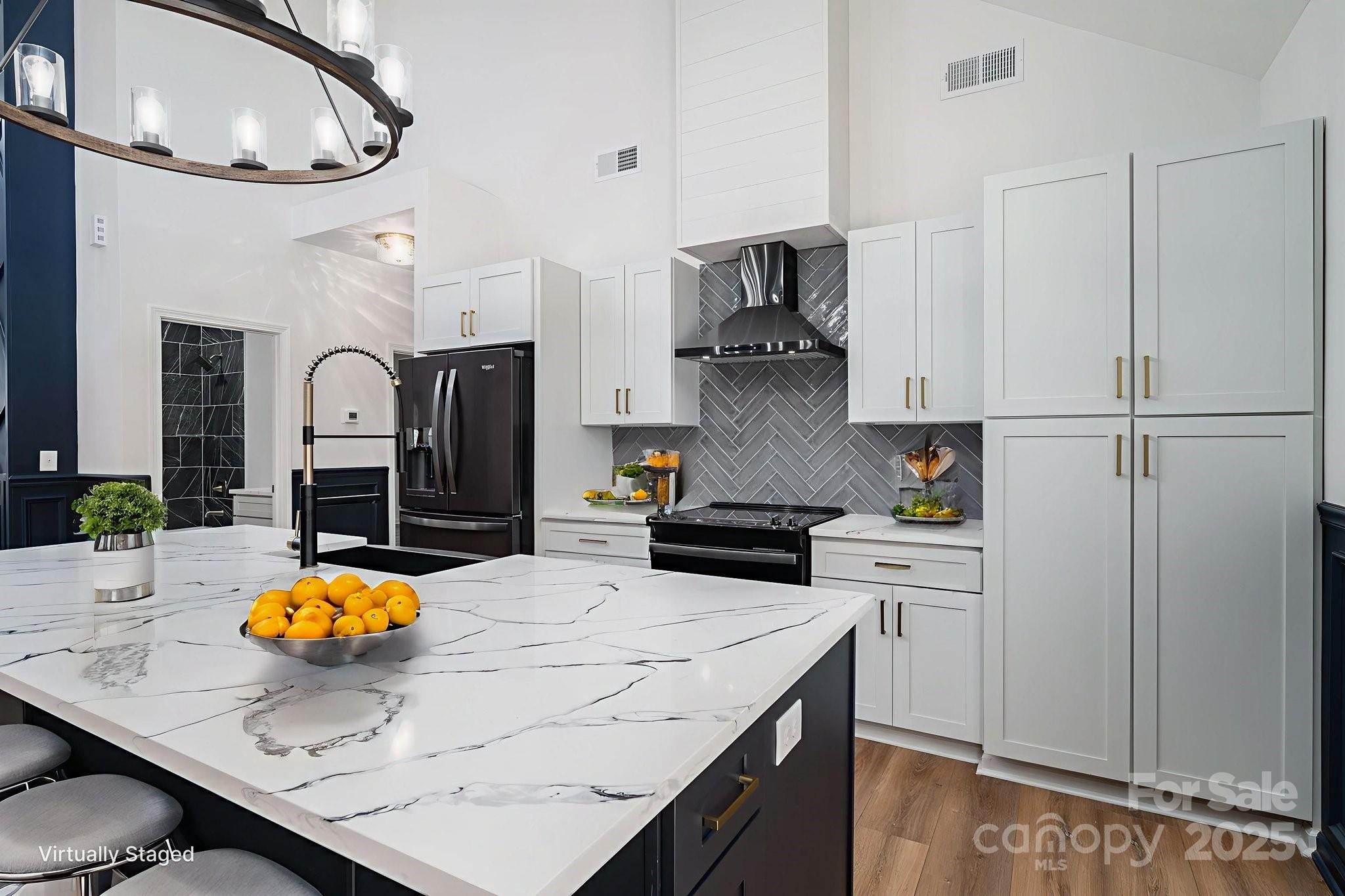 a kitchen with stainless steel appliances granite countertop a sink a stove and refrigerator