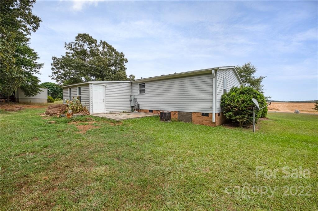 3808 Belk Mill Road Wingate, NC 28174 - Photo 17 of 18 a backyard of a house with table and chairs