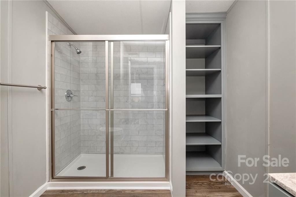 3808 Belk Mill Road Wingate, NC 28174 - Photo 8 of 18 a bathroom with a glass shower door
