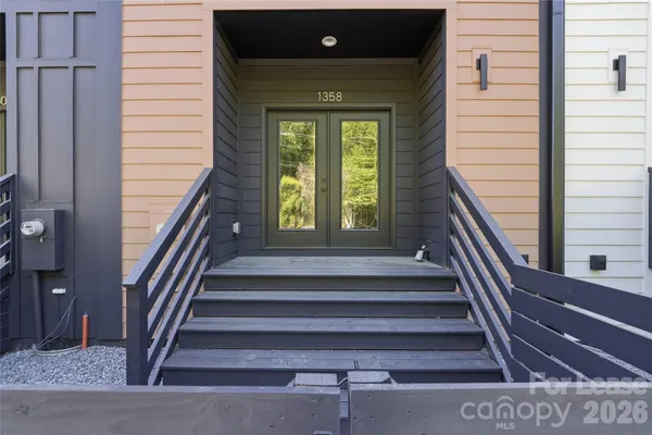 a view of balcony with wooden floor and fence