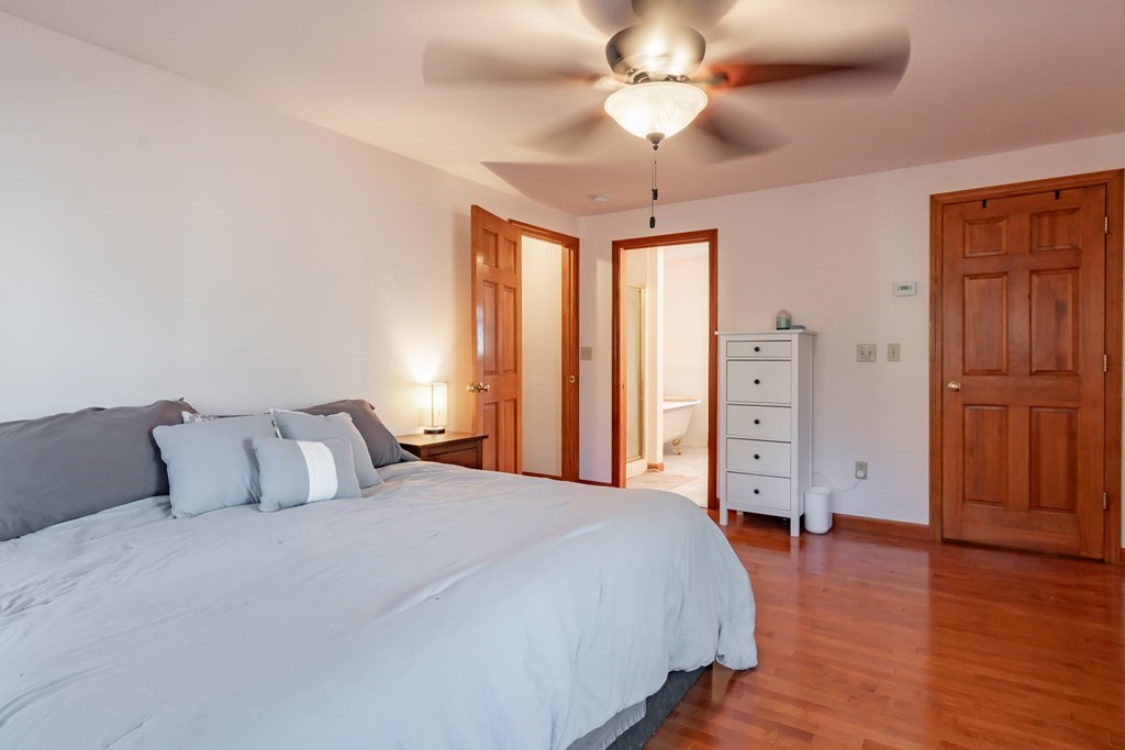 38 Westview Road Brookline, NH 03033 - Photo 12 of 28 a bedroom with a bed and wooden floor