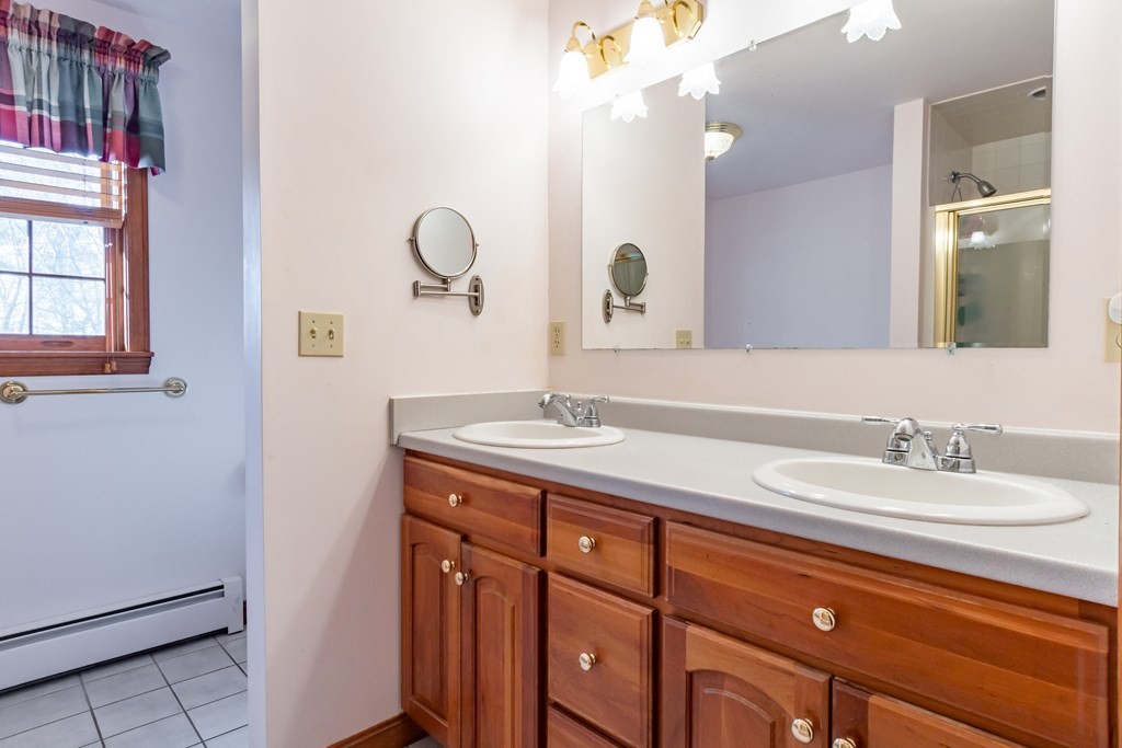 38 Westview Road Brookline, NH 03033 - Photo 13 of 28 a bathroom with a double vanity sink and a mirror