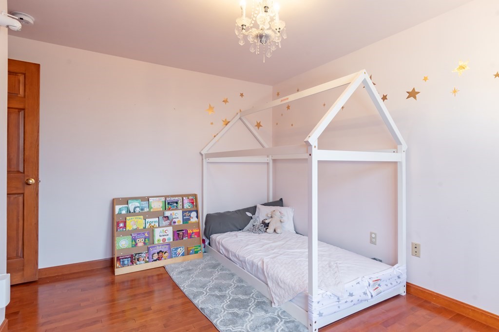 38 Westview Road Brookline, NH 03033 - Photo 16 of 28 a room that has a bed and a chandelier