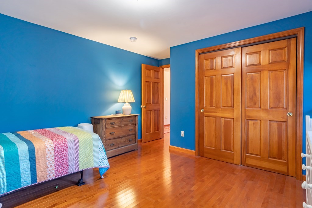 38 Westview Road Brookline, NH 03033 - Photo 18 of 28 a bedroom with a bed and wooden floor