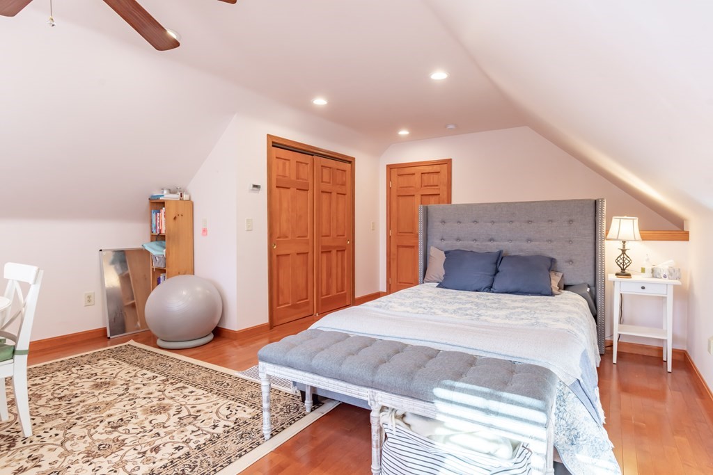 38 Westview Road Brookline, NH 03033 - Photo 20 of 28 a bedroom with a bed and wooden floor