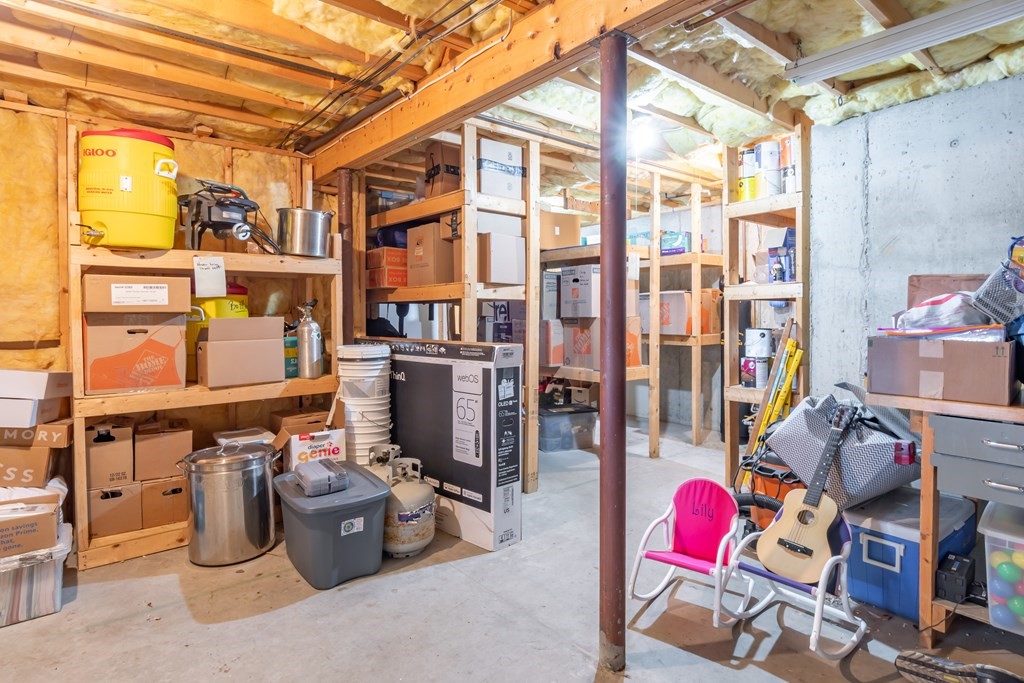 38 Westview Road Brookline, NH 03033 - Photo 24 of 28 a storage room with furniture and a chandelier