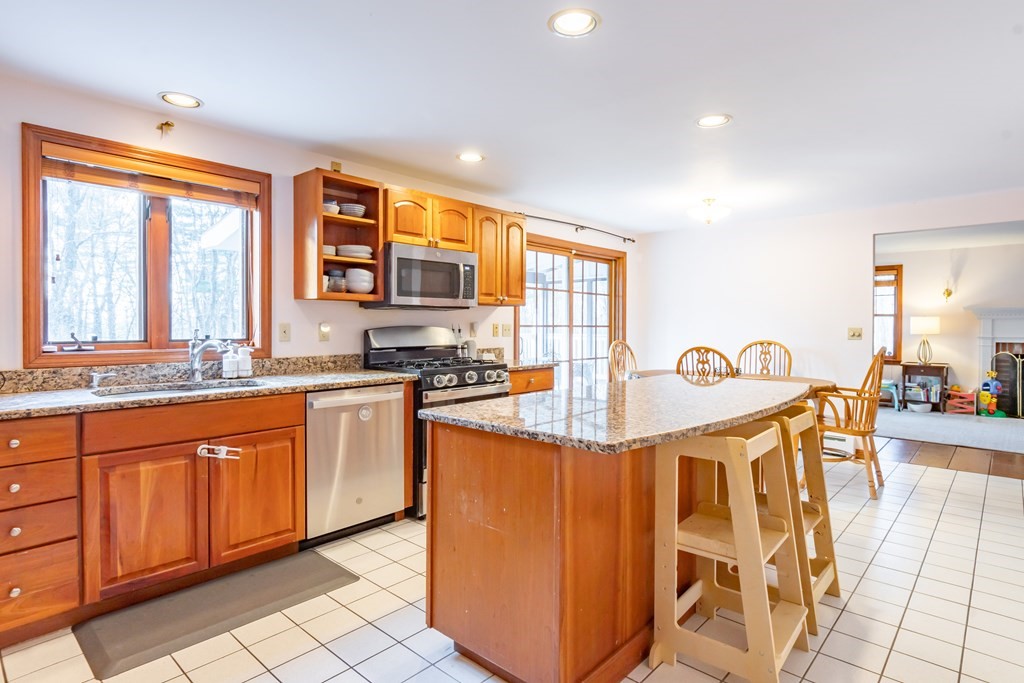 38 Westview Road Brookline, NH 03033 - Photo 8 of 28 a kitchen with stainless steel appliances granite countertop a stove a sink and a refrigerator